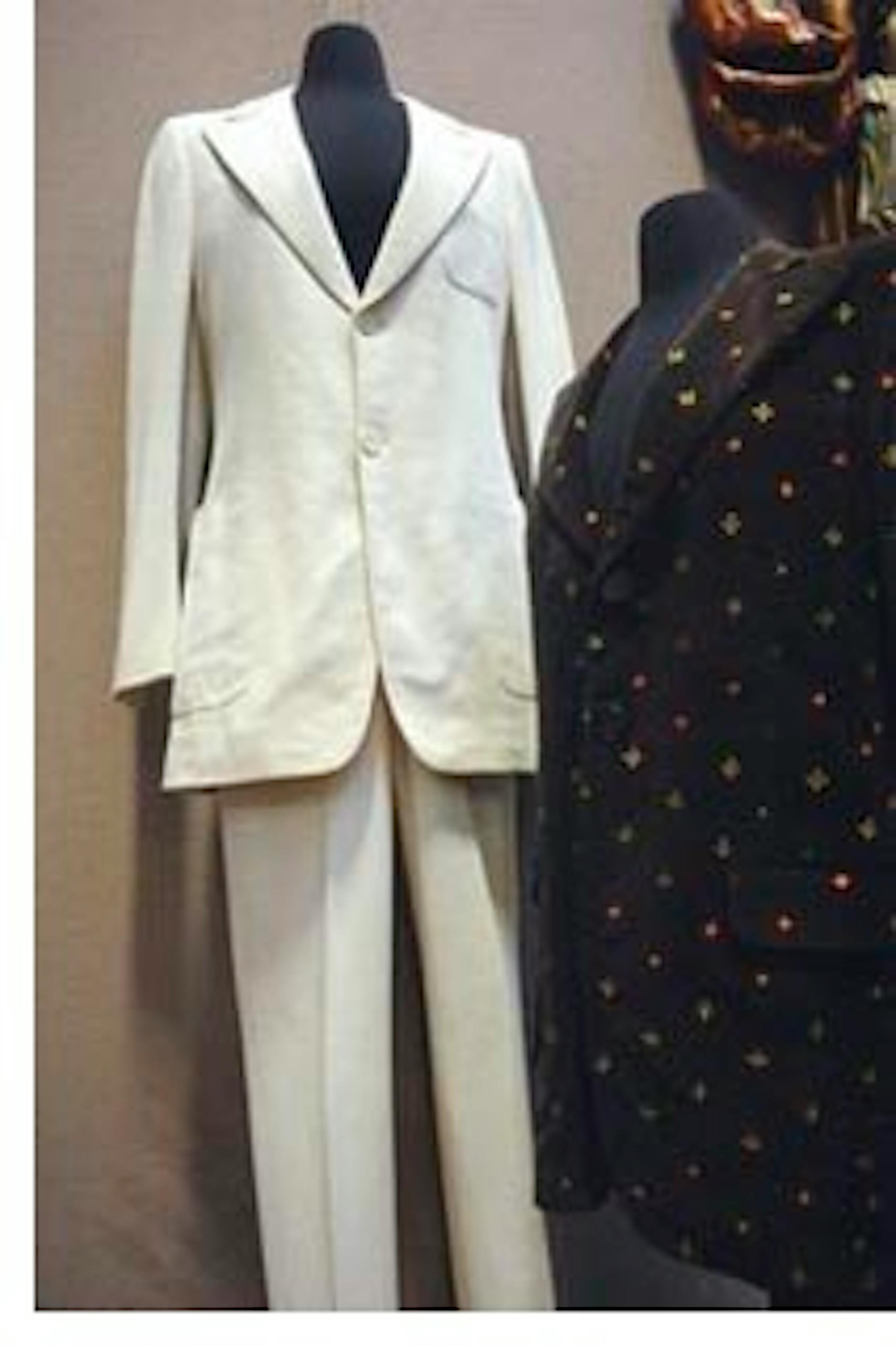 FILE -- This Monday, Dec. 13, 2010 file photo shows the suit John Lennon wore in the photo on the cover of The Beatles' Abbey Road album, left, and a blazer he wore during his video for the song "Imagine," at Braswell Galleries in Norwalk, Conn. The seller's former landlord has sued the gallery that auctioned the late Beatle's suit for $46,000, trying to get at the proceeds to satisfy a rent debt. (AP Photo/The Hour, Matthew Vinci, File) MANDATORY CREDIT