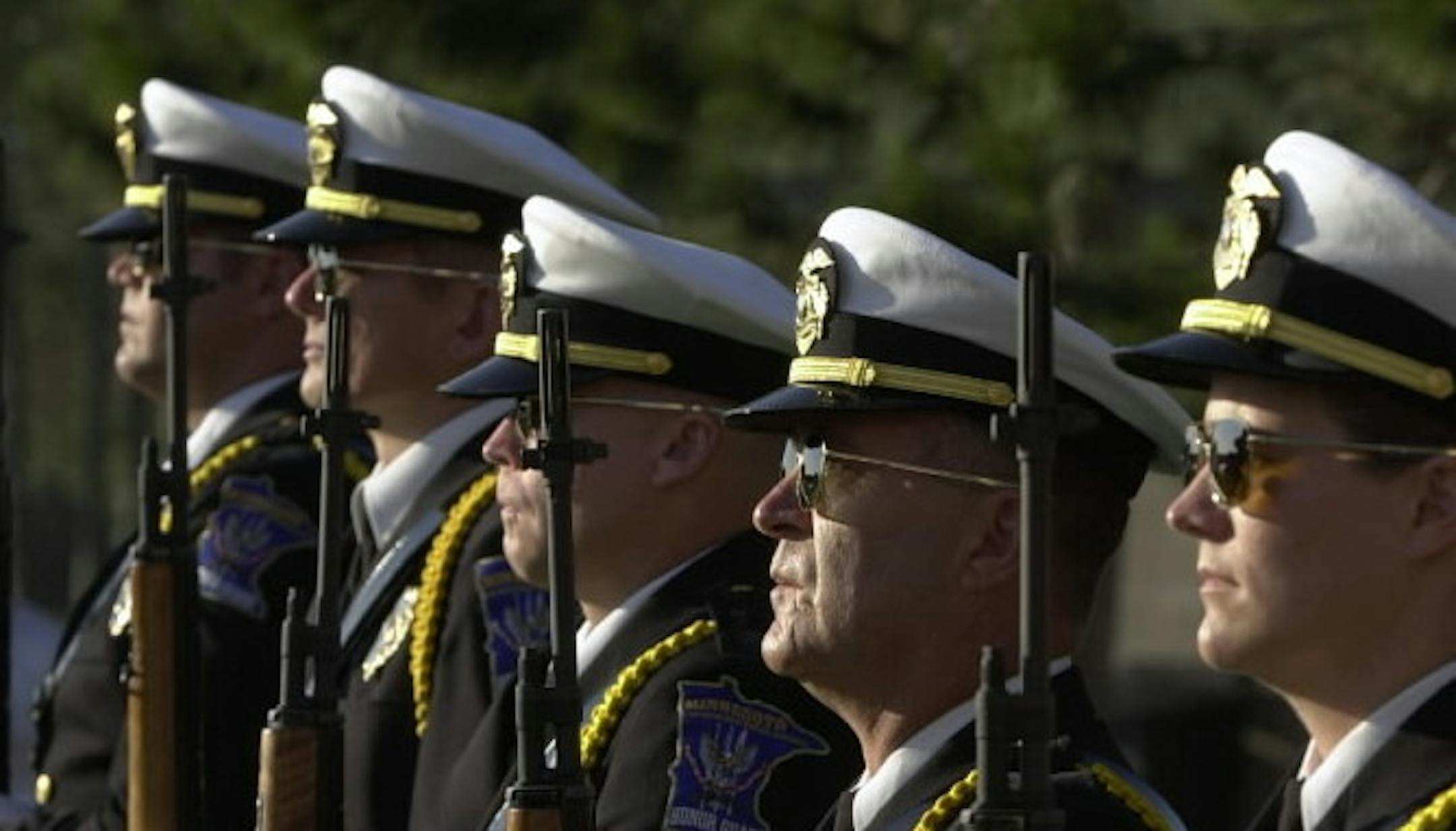 IN THIS PHOTO: Members of the rifle detail of the Minnesota Law Enforcement Memorial Association (LEMA) Honor Guard stood at attention during a full-dress demonstration for camp members.