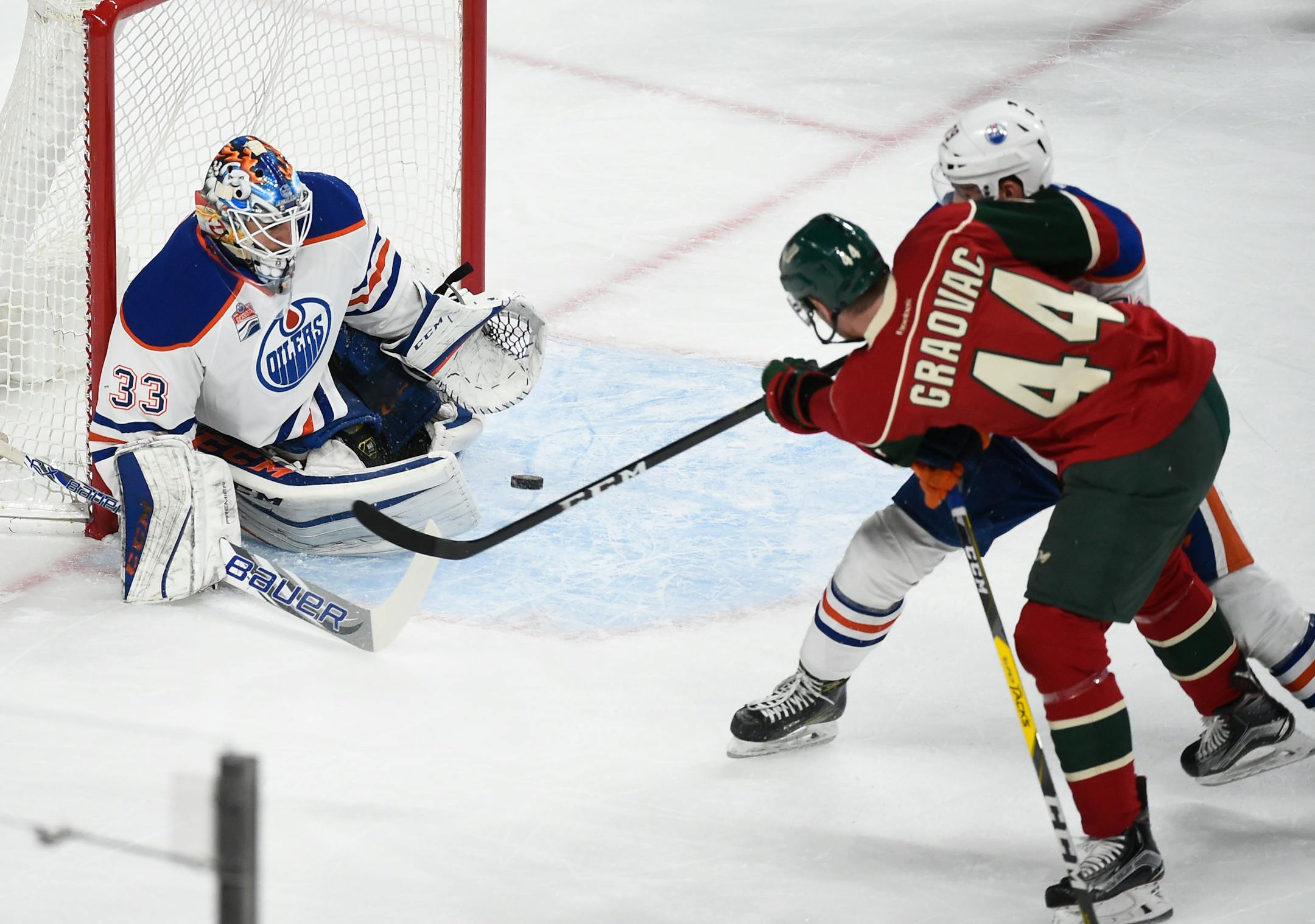 Edmonton Oilers' goalie Cam Talbot, left, stops a shot by Minnesota Wild's center Tyler Graovac (44) while Edmonton Oilers' Jason Pominville, right, tries to stop Graovac during the first period of an NHL hockey game, Friday, Dec. 9, 2016, in St. Paul, Minn. (AP Photo/Craig Lassig)