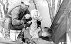April 14, 1952 Rescuer Ed Steffen lifts baby to safety from St. Paul flooding : Girl is Carol Kluznik, 1, 56 W. fair field street. April 15, 1952 Pete