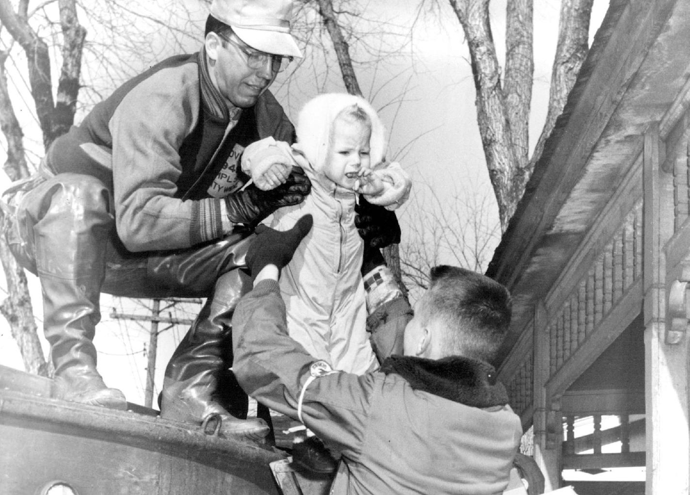 April 14, 1952 Rescuer Ed Steffen lifts baby to safety from St. Paul flooding : Girl is Carol Kluznik, 1, 56 W. fair field street. April 15, 1952 Peter Marcus, Minneapolis Star Tribune