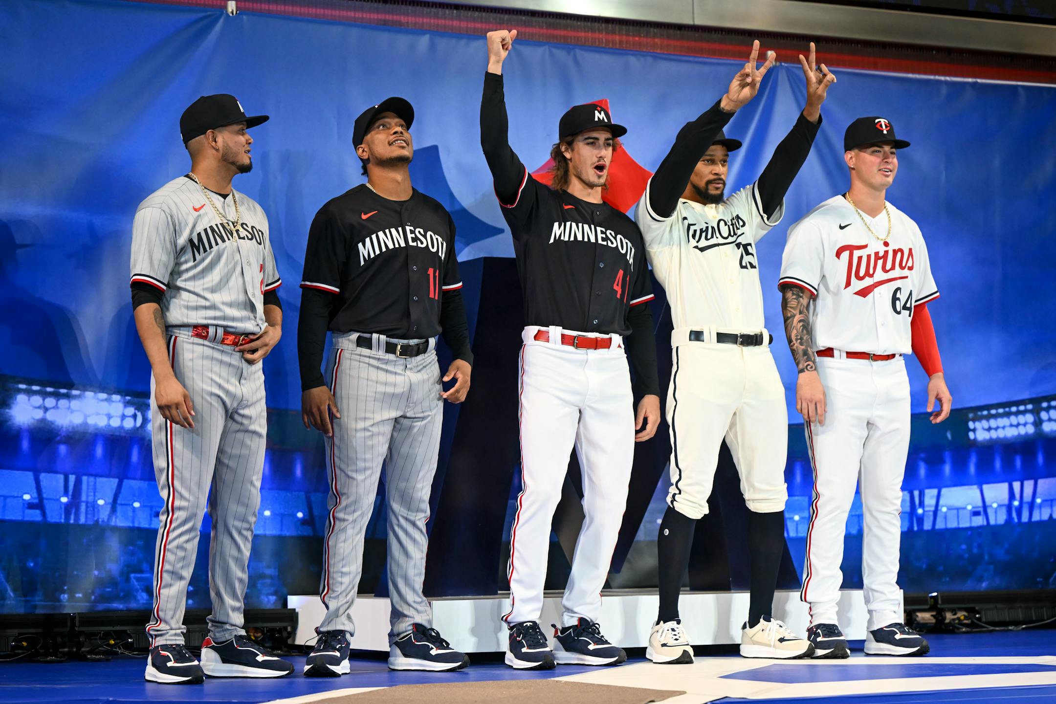 From left, Twins players Luis Arraez, Jorge Polanco, Joe Ryan, Byron Buxton and Jose Mirana pose for a photo in their new uniforms after a reveal Friday, Nov. 18, 2022 at the Mall of America in Bloomington, Minn.