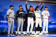 From left, Twins players Luis Arraez, Jorge Polanco, Joe Ryan, Byron Buxton and Jose Mirana pose for a photo in their new uniforms after a reveal Frid