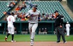 Minnesota Twins' Brian Dozier rounds the bases after hitting a solo home run in the first inning of a baseball game against the Baltimore Orioles, Sun