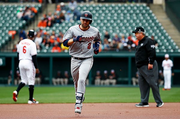 Minnesota Twins' Brian Dozier rounds the bases after hitting a solo home run in the first inning of a baseball game against the Baltimore Orioles, Sun