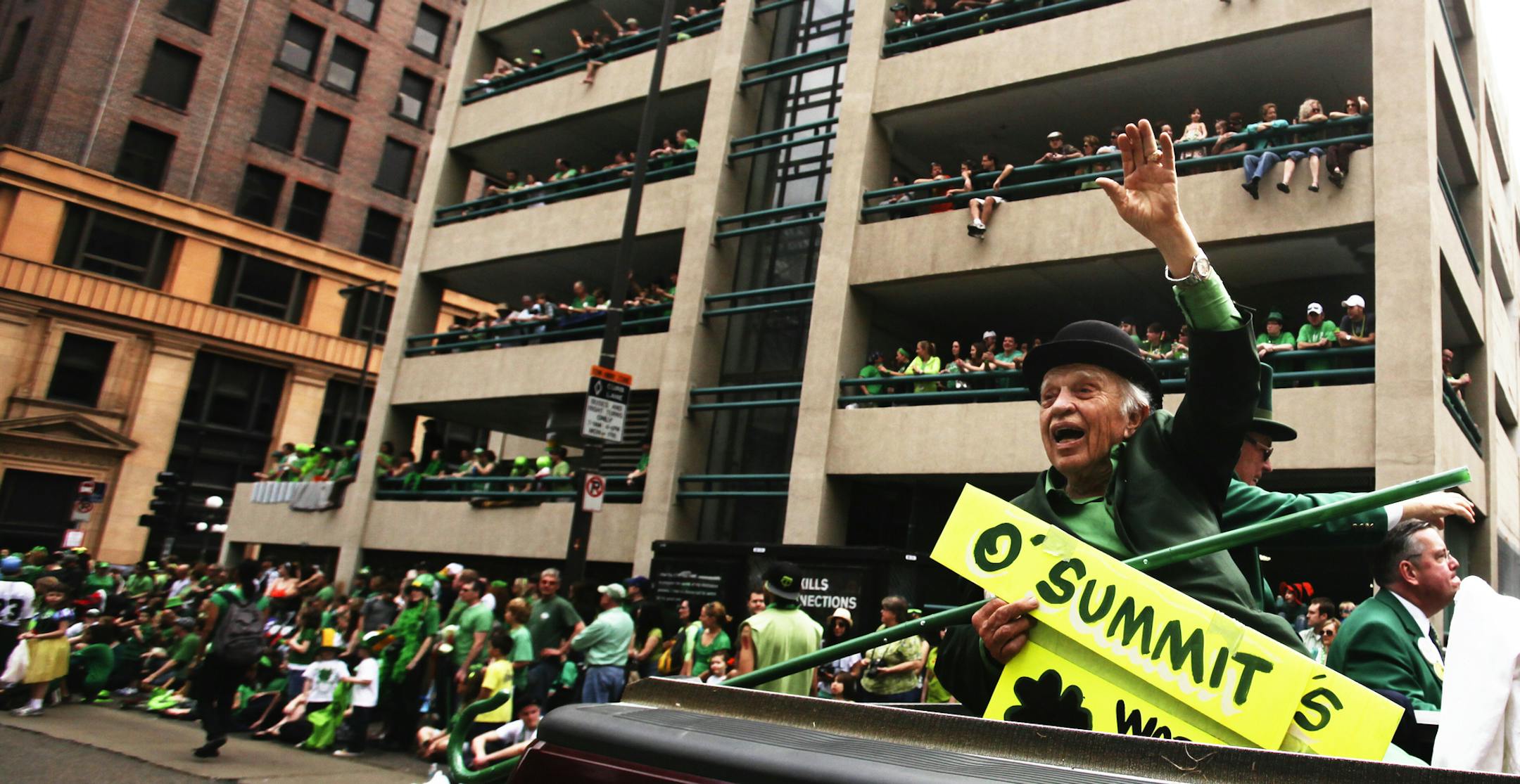 Ninety year-old Glen Olson waved to the huge St. Patrick's Day parade crowd from the back of a pickup truck along 5th Steet Saturday March 17, 2012, in downtown St. Paul, MN, for what Olson estimated was his 50th St. Patrick's Day parade in St. Paul.] DAVID JOLES*djoles@startribune.com - The 46th Annual St. Patrick's Day Parade in St. Paul experienced both near-record temps and crowds while heading through downtown St. Paul on 5th Street. March 17, 2012, in St. Paul, MN,] DAVID JOLES*djoles@star