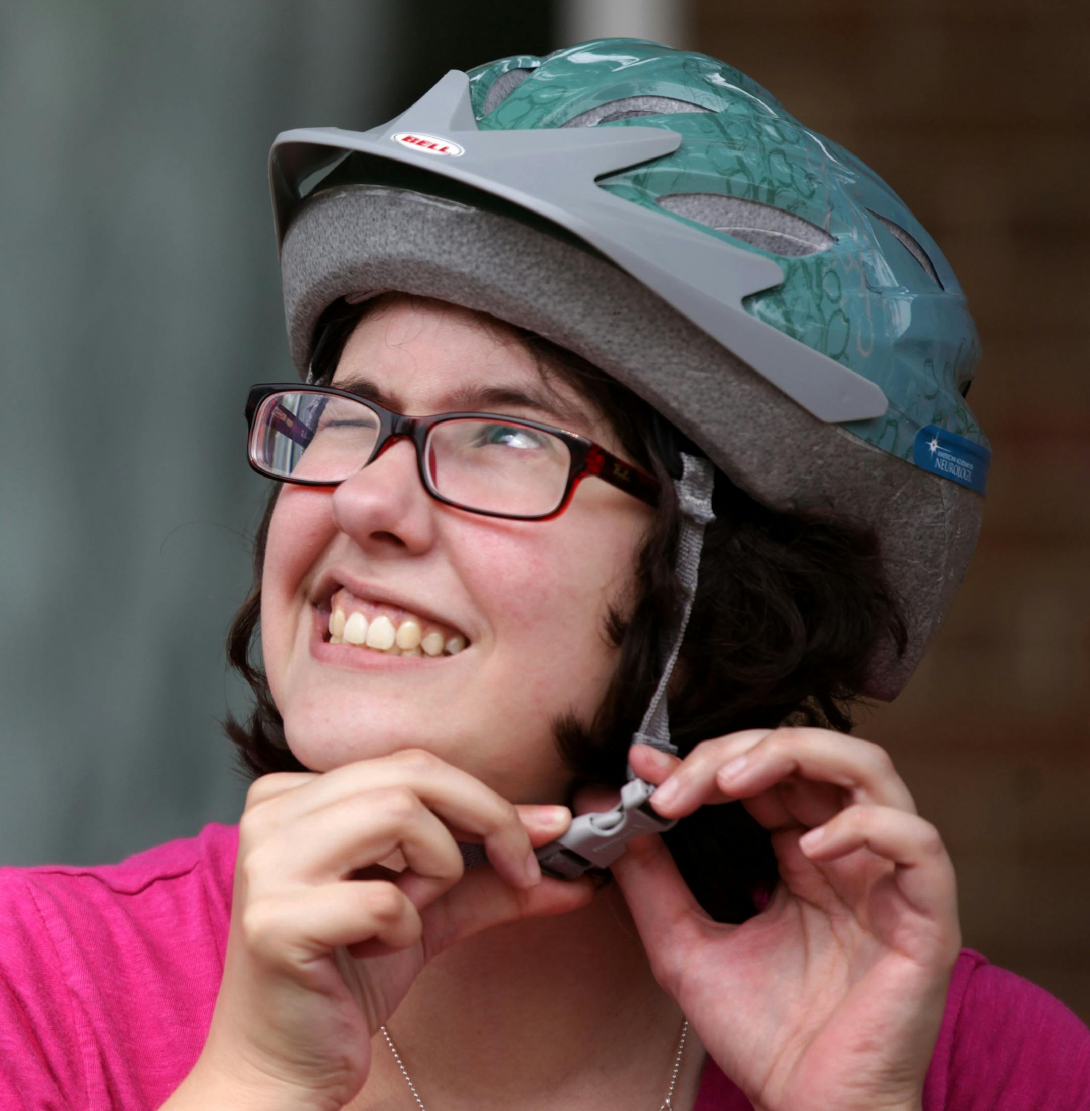 Vanessa Laven adjusts her helmet after a break during the Learn-to-Ride class on Saturday morning at Matthews Park. ] SPOKES, a non-profit in Minneapolis, offers Learn-to-Ride bike classes for adults and teens at Matthews Park in Cedar-Riverside. MONICA HERNDON monica.herndon@startribune.com Minneapolis, MN 07/19/14