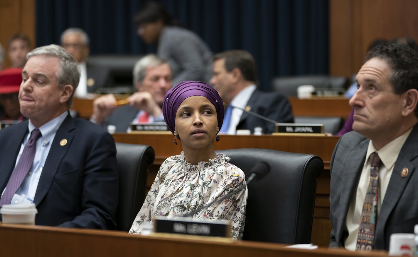 Rep. Ilhan Omar, D-Minn., sits with fellow Democrats, Rep. David Trone, D-Md., left, and Rep. Mike Levin, D-Calif., right, on the House Education and Labor Committee during a bill markup, on Capitol Hill in Washington, Wednesday, March 6, 2019. Omar stirred controversy last week saying that Israel's supporters are pushing U.S. lawmakers to take a pledge of "allegiance to a foreign country." Omar is not apologizing for that remark, and progressives are supporting her. (AP Photo/J. Scott Applewhit