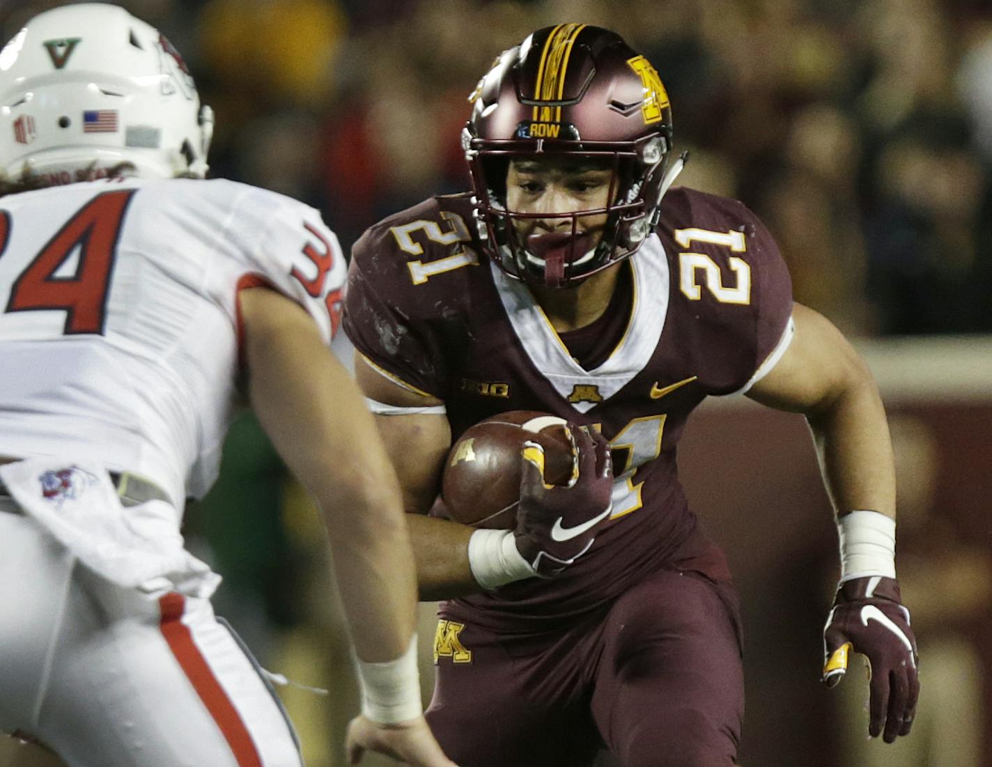 Minnesota running back Bryce Williams (21) runs against Fresno State linebacker George Helmuth (34) in the fourth quarter of an NCAA college football game, Saturday, Sept. 8, 2018 in Minneapolis. Minnesota defeated Fresno State 21-14. (AP Photo/Andy Clayton-King)