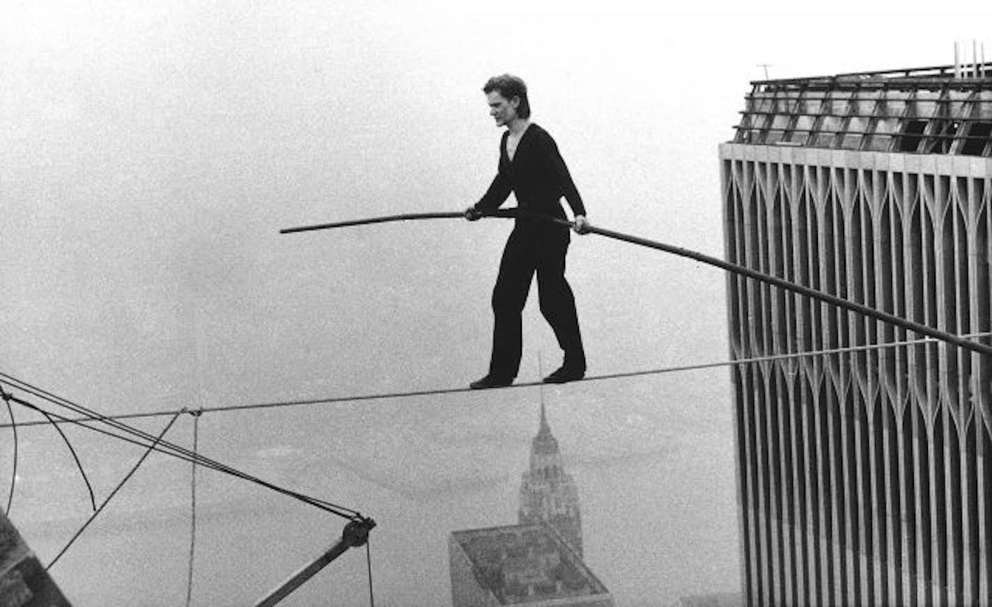 In this Aug. 7, 1974 file photo, Philippe Petit, a French high wire artist, walks across a tightrope suspended between the World Trade Center's Twin Towers in New York.