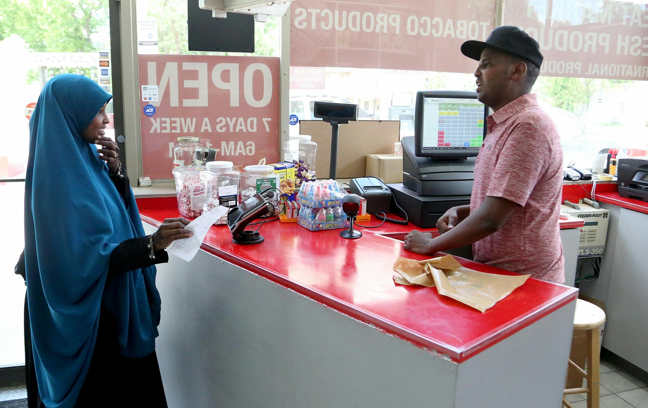 Saido Farah, left, chatted with halal market owner Abdiaziz Farah, who is her cousin. He is catering to Shakopee’s growing Somali-American population.