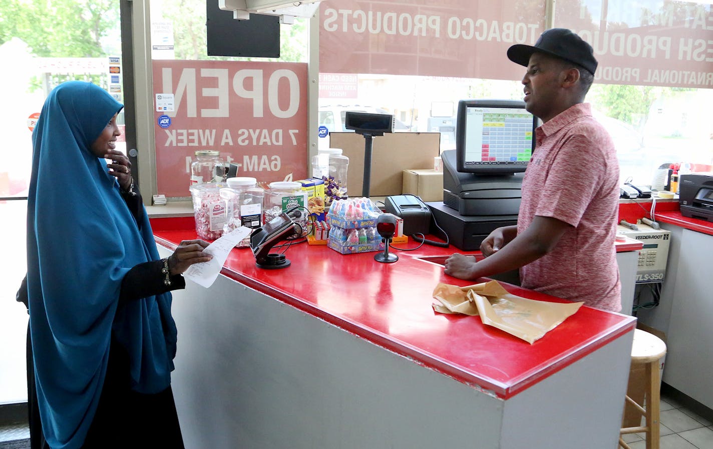 Saido Farah, left, chatted with halal market owner Abdiaziz Farah, who is her cousin. He is catering to Shakopee&#x2019;s growing Somali-American population.