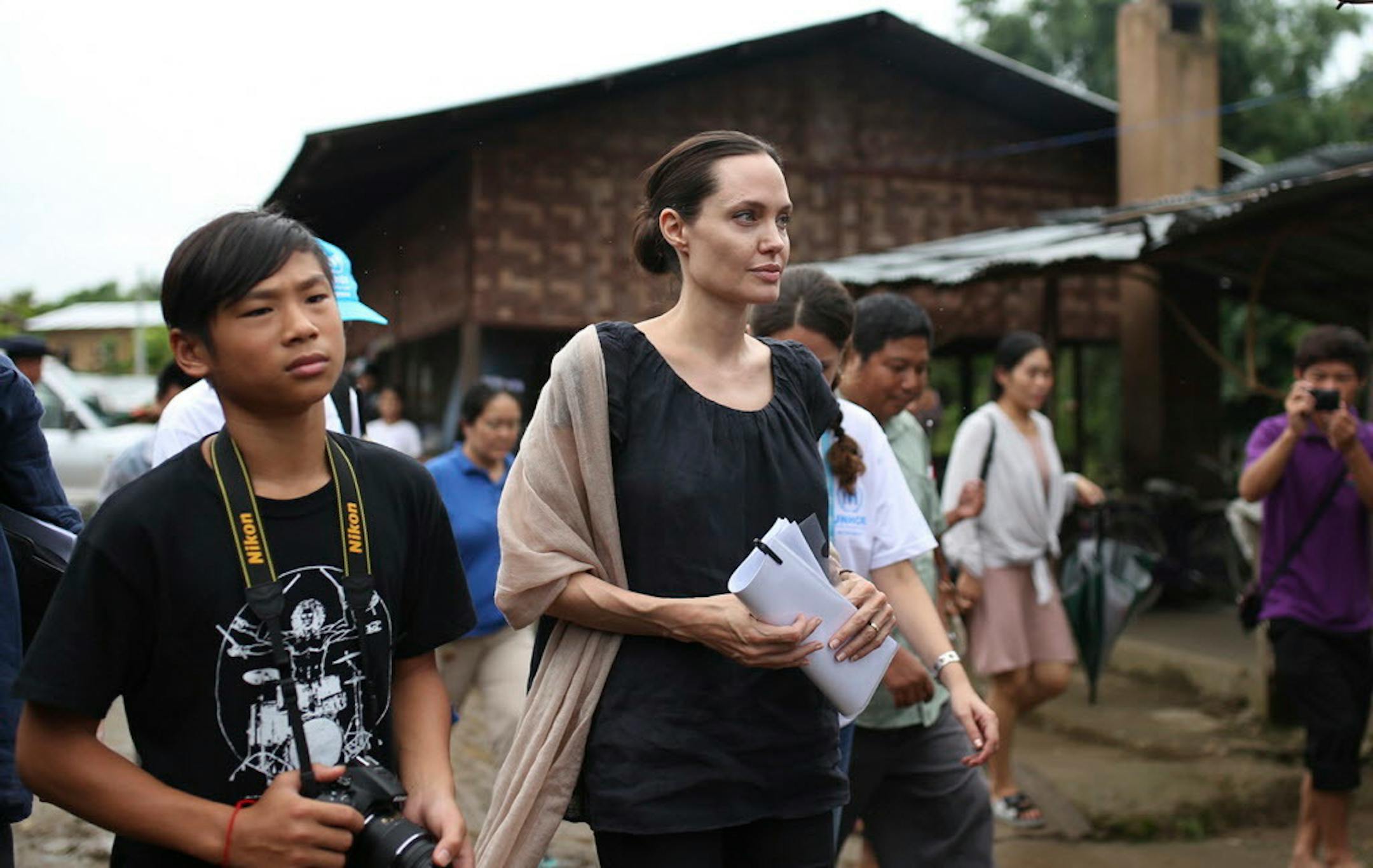In July 2015, actress and UNHCR special envoy Angelina Jolie Pitt walks with her son Maddox, left, as they visit Jan Mai Kaung refugee camp in Myitkyina, Kachin State, Myanmar.