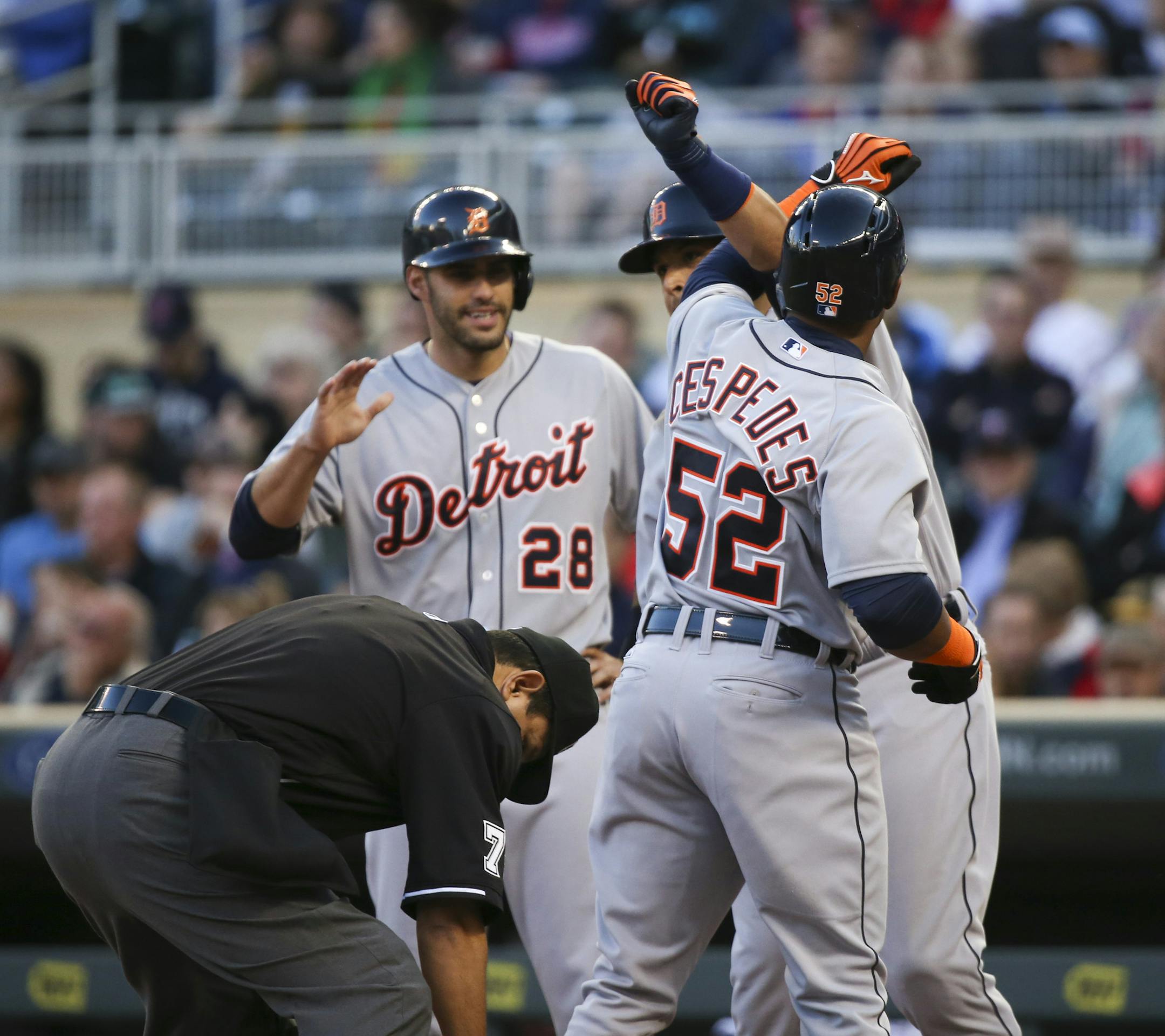 The Tigers' Yoenis Cespedes (52) was congratulated at home by teammates Victor Martinez and J.D. Martinez, left, after they scored on Cespedes' three-run homer in the first inning Monday night.