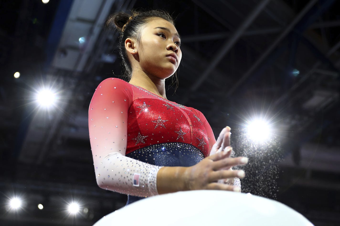 Sunisa Lee of the U.S. prepares her hands at the floor during women's team final at the Gymnastics World Championships in Stuttgart, Germany, Tuesday, Oct. 8, 2019. (AP Photo/Matthias Schrader)