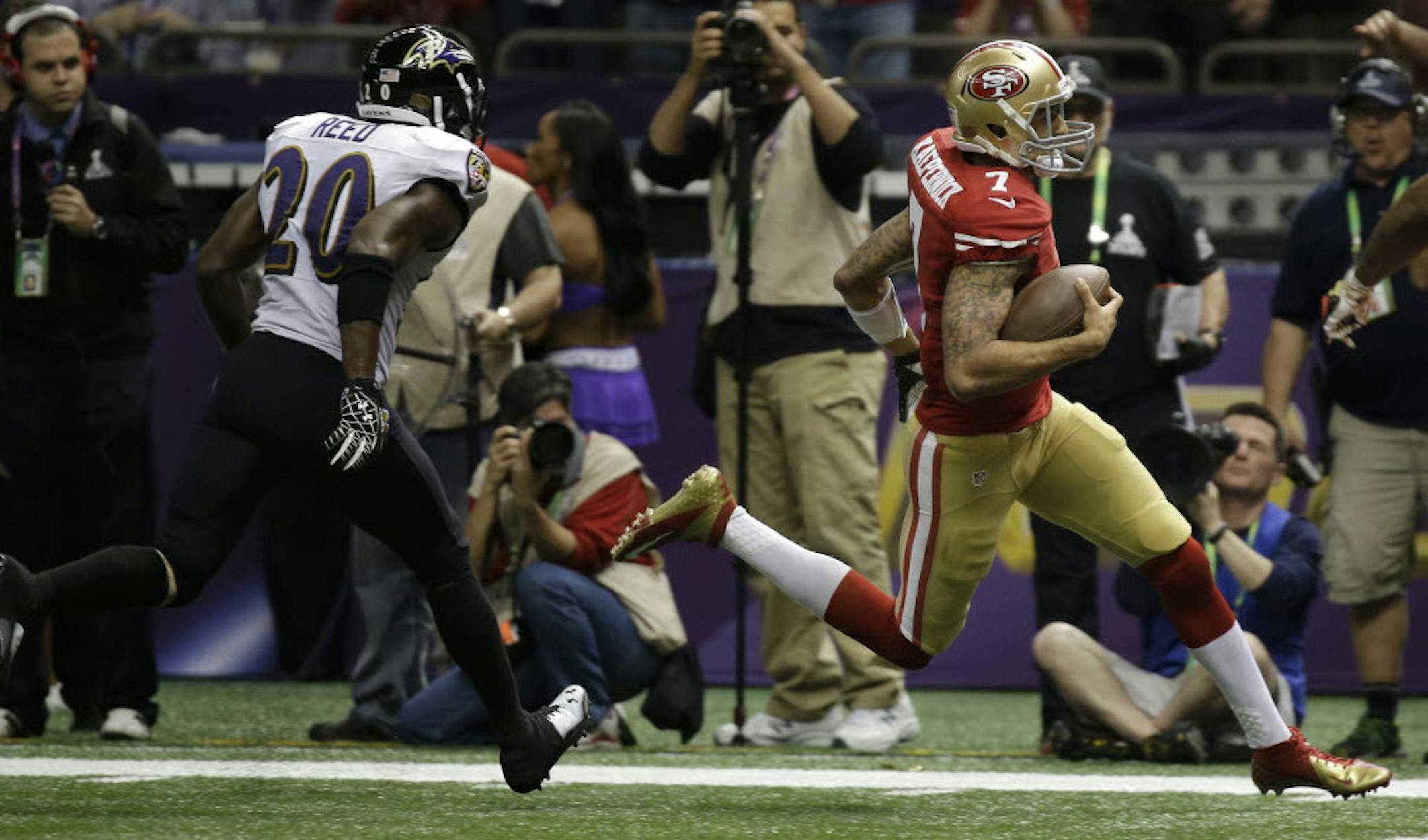 49ers quarterback Colin Kaepernick ran into the end zone for a 15-yard touchdown, chased by Ravens safety Ed Reed, during Sunday's Super Bowl.