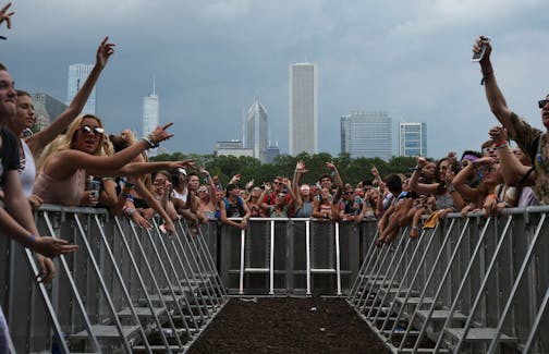 Concertgoers cheer as the band White Reaper takes the stage during Lollapalooza at Grant Park in Chicago on Thursday, Aug. 3, 2017.