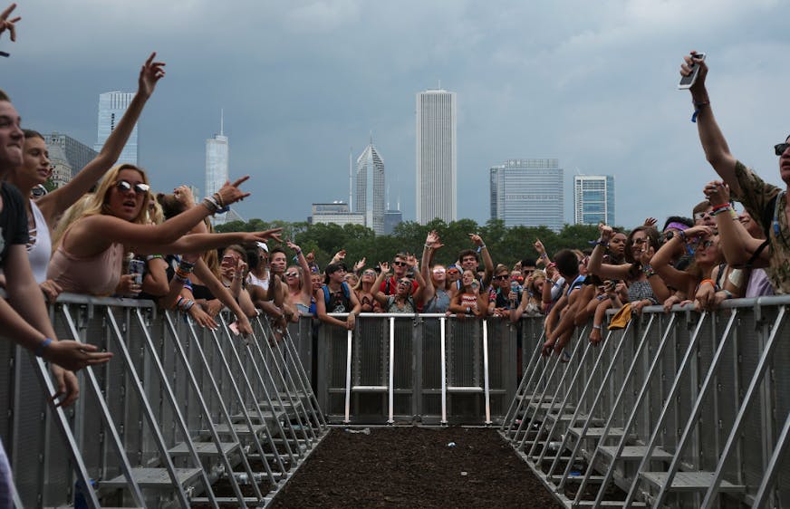 Concertgoers cheer as the band White Reaper takes the stage during Lollapalooza at Grant Park in Chicago on Thursday, Aug. 3, 2017.
