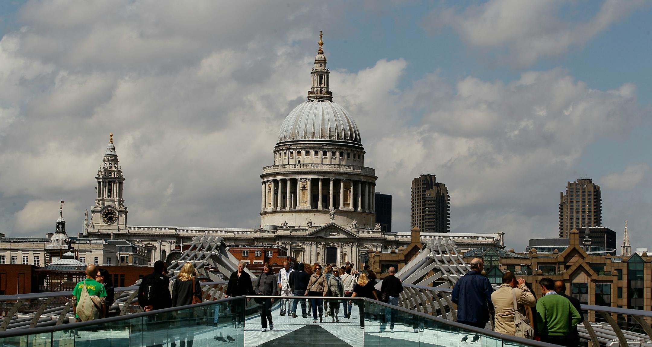 Pedestrians walk across the Millenium Bridge in front of St Paul's Cathedral in London, Thursday, June 16, 2011. The cathedral is seen without scaffolding for the first time in 15 years, as a cleaning and restoration project costing 40 million pounds (US$ 64.37million. euro 45.69 million). It is the first time in its history that the building has been comprehensively restored inside and out since its completion in 1711. (AP Photo/Kirsty Wigglesworth)