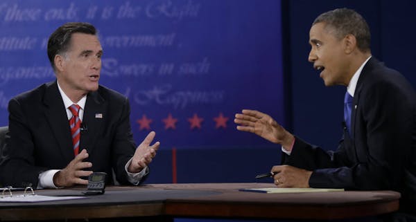 President Barack Obama, right, and Republican presidential nominee Mitt Romney discuss a point during the third presidential debate.