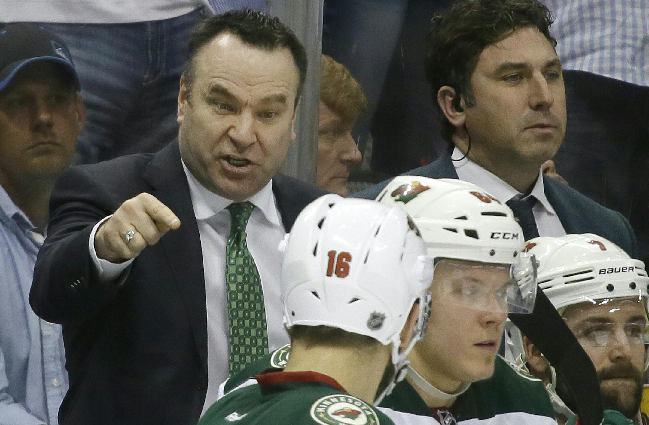 Minnesota Wild coach John Torchetti, left, makes a point while talking to left wing Jason Zucker (16) during the third period of Game 1 in a first-round NHL hockey Stanley Cup playoff series against the Dallas Stars on Thursday, April 14, 2016, in Dallas. The Stars won 4-0. (AP Photo/LM Otero)