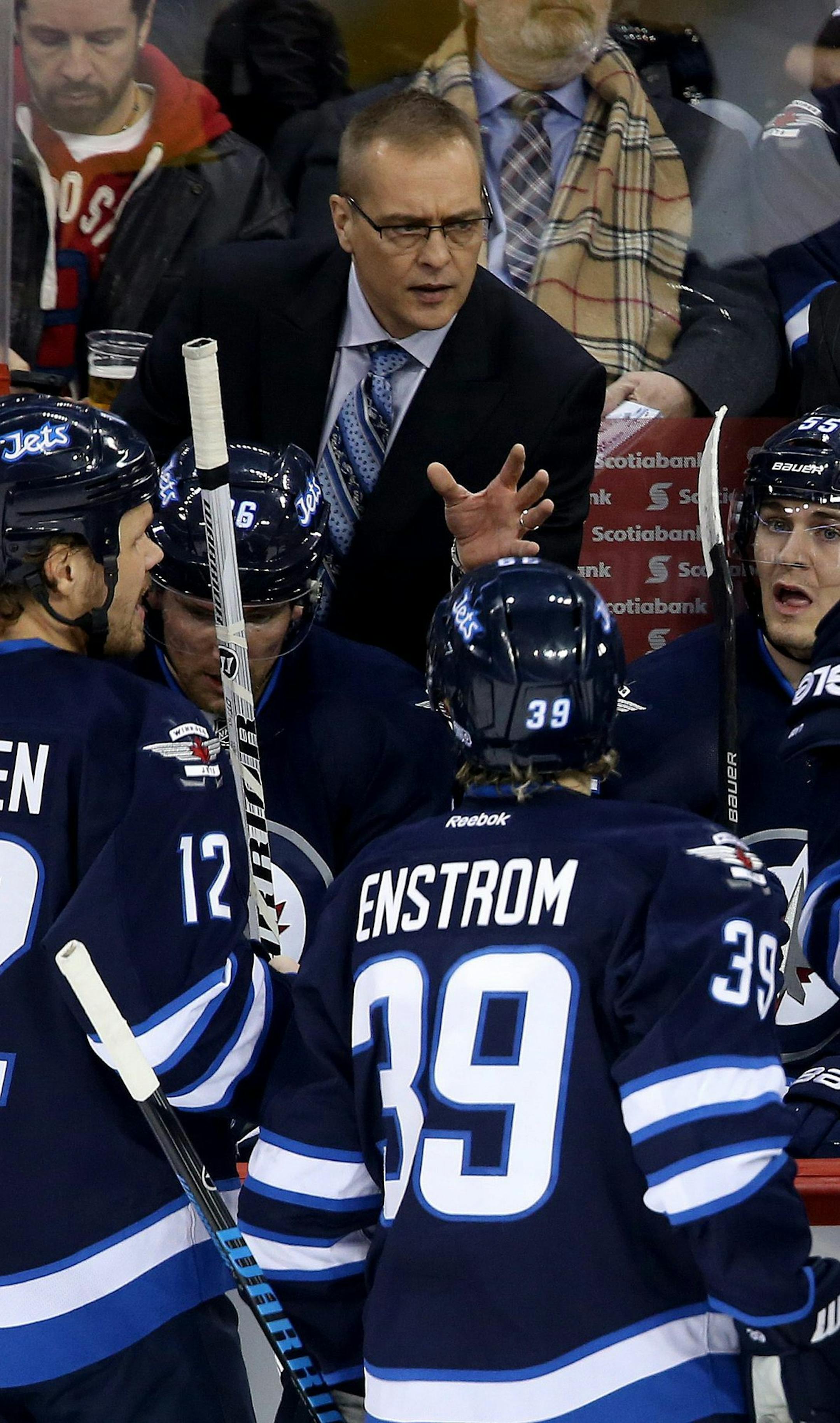 New Winnipeg Jets head coach Paul Maurice and assistant coach Charlie Huddy instruct the team during first period NHL hockey action against the Phoenix Coyotes in Winnipeg, Canada, Monday, Jan. 13, 2014. (AP Photo/The Canadian Press, Trevor Hagan)