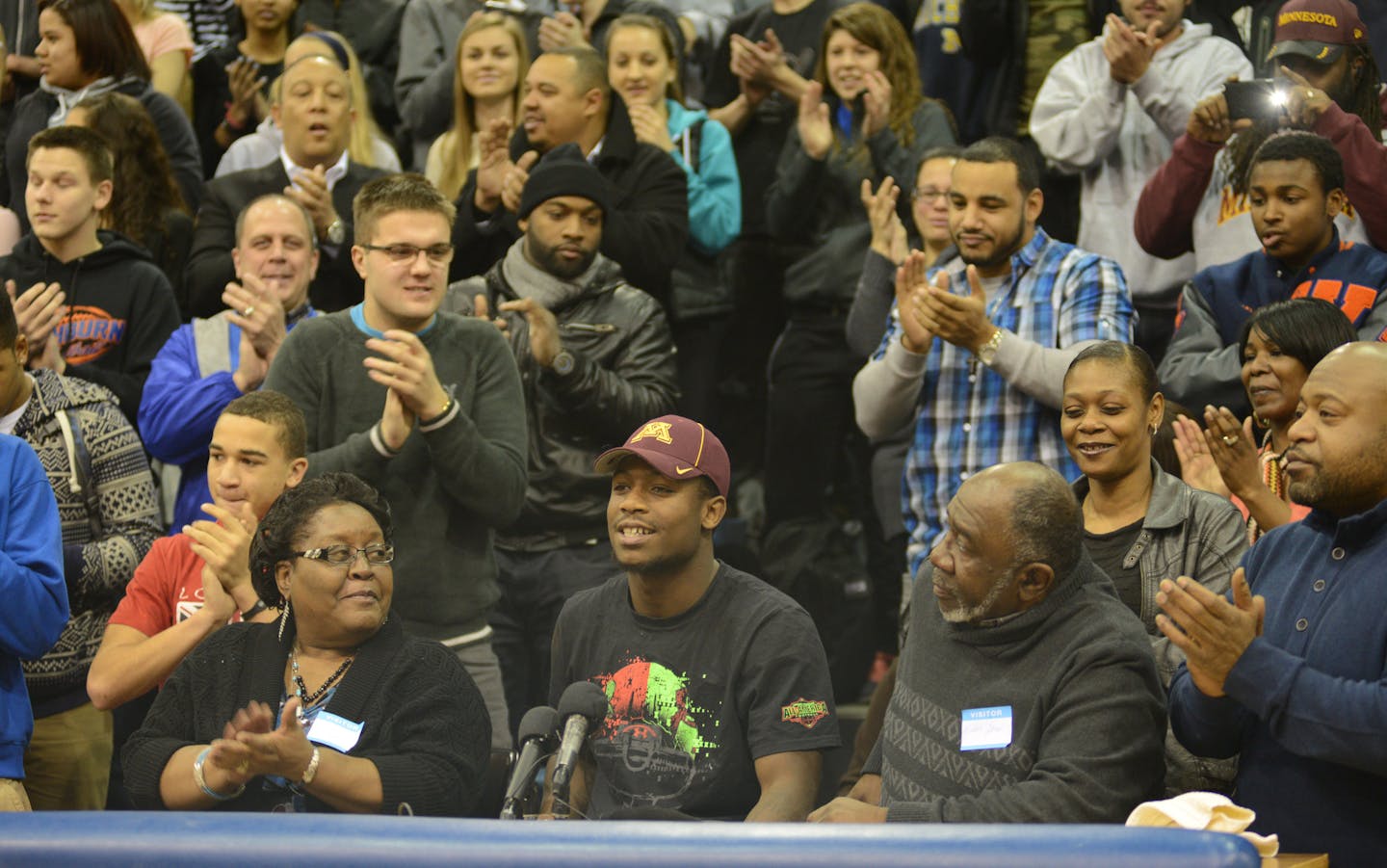 Jeff Jones, from Washburn High is one of the top running backs in the country and he selected the U of M football program .He put on his U of M hat with his grandmother Doris jones and grandfather Willie Jones looking o n in a packed Washburn High gym. ] Richard.Sennott@startribune.com Richard Sennott/Star Tribune Minneapolis , Minn. Wednesday 2/5/2014) ** (cq)