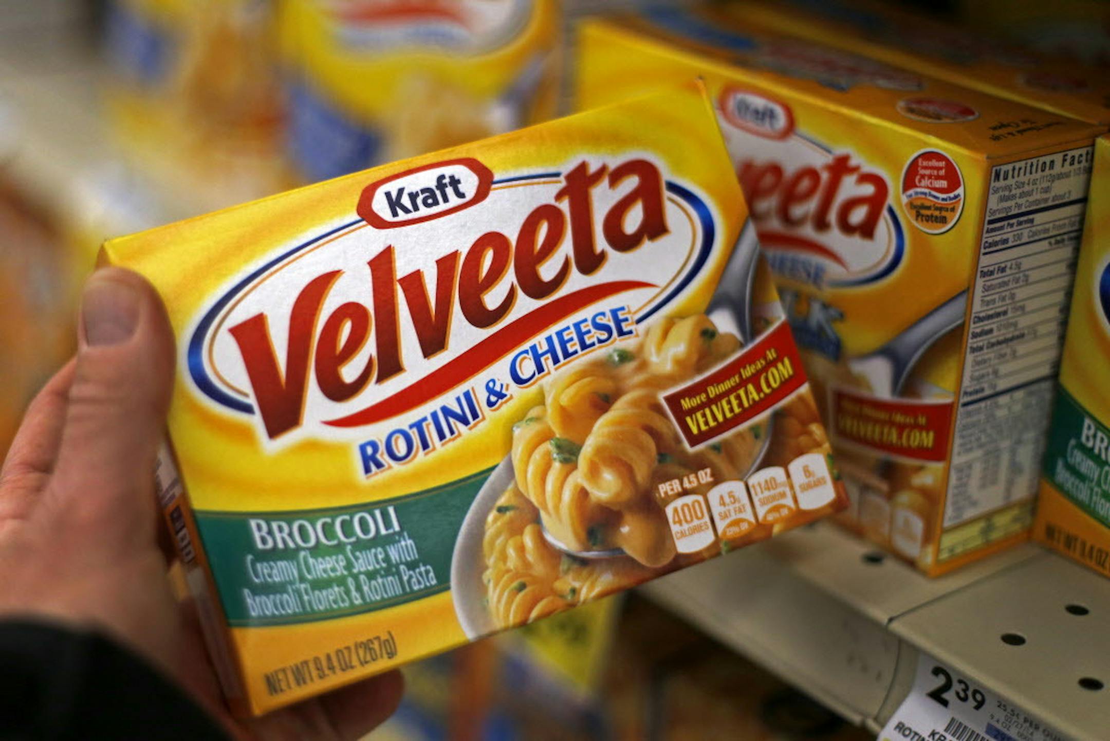 FILE - This Tuesday, April 29, 2014, file photo, shows a display of Kraft Velveeta rotini and cheese at a grocery market in Pittsburgh. On Wednesday, Aug. 12, 2015, Kraft Heinz announced it is cutting about 2,500 jobs as part of its plan to slash costs after the food companies combined. (AP Photo/Gene J. Puskar, File)