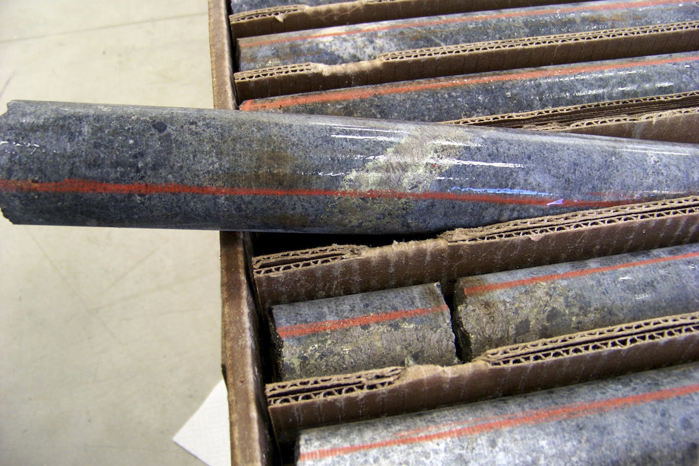 FILE - In this Oct. 4, 2011, file photo, a core sample drilled from underground rock near Ely, Minn., shows a band of shiny minerals containing copper, nickel and precious metals, center, that Twin Metals Minnesota LLC, hopes to mine near the Boundary Waters Canoe Area Wilderness in northeastern Minnesota. (AP Photo/Steve Karnowski, File)