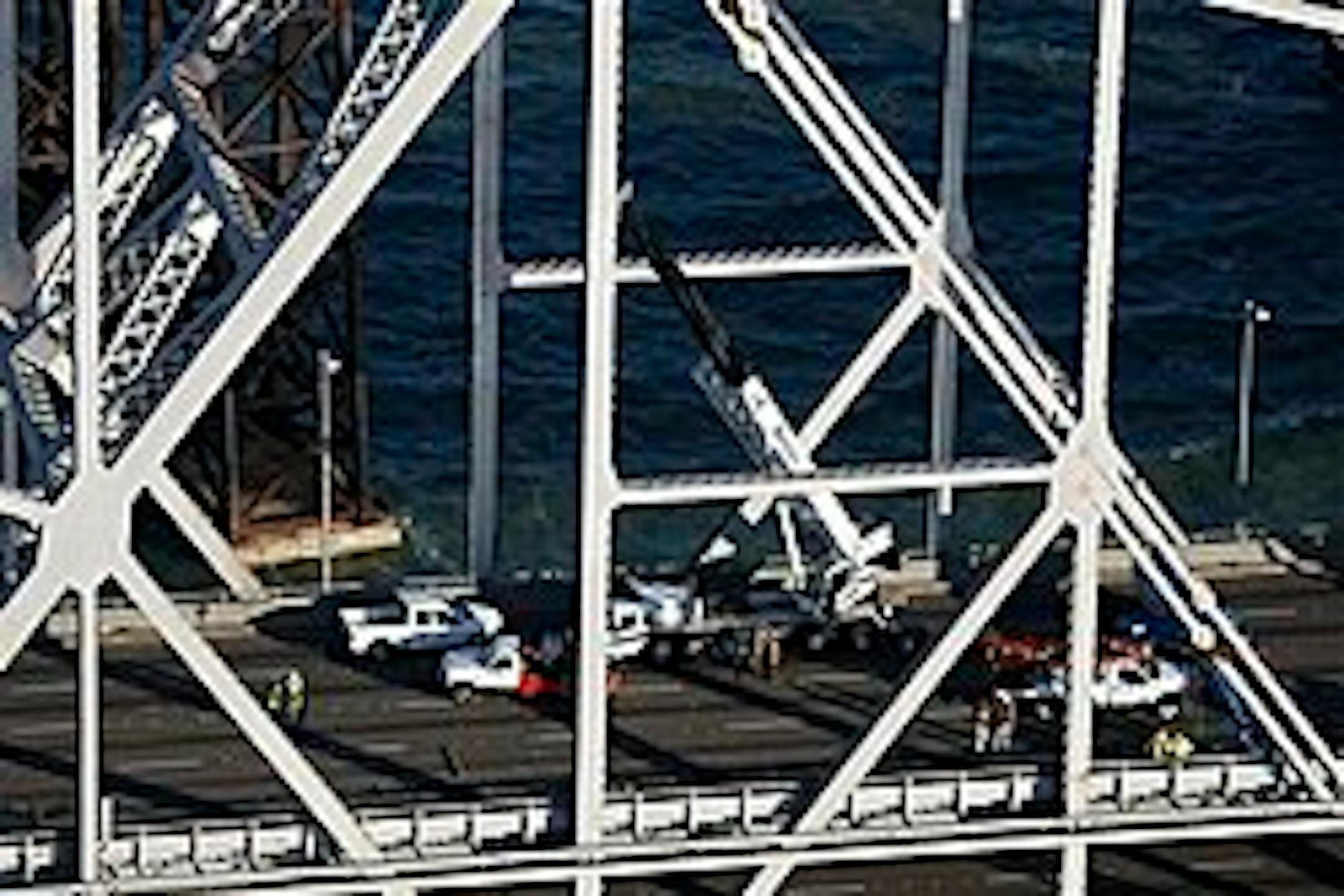 Crews work on the Bay Bridge in San Francisco, Wednesday, Oct. 28, 2009. The San Francisco-Oakland Bay Bridge has been closed indefinitely after a rod installed during last month's emergency repairs snapped, causing a traffic nightmare for the 280,000 motorists who cross the landmark span every day.(AP Photo/Marcio Jose Sanchez)