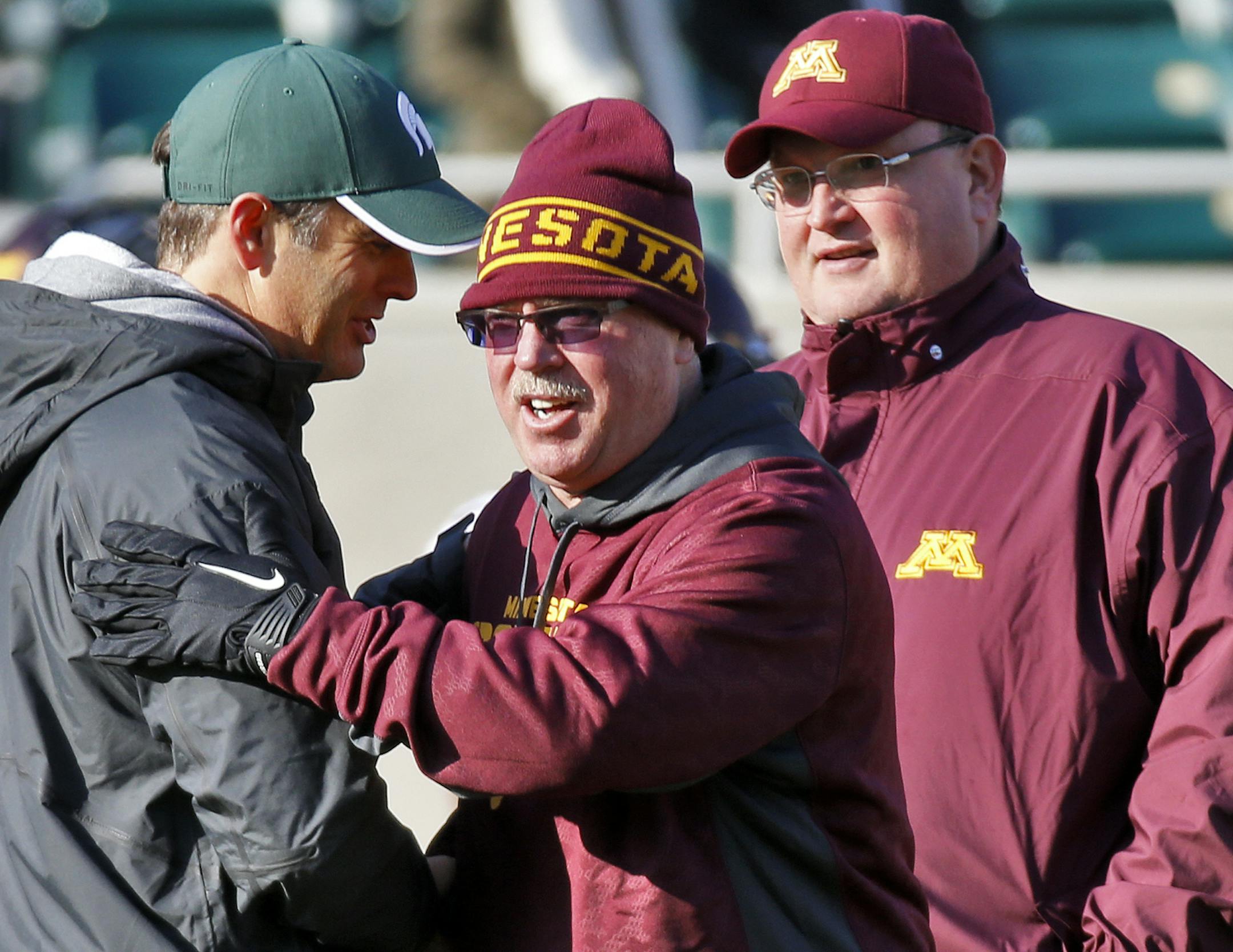 Minnesota Gophers vs. Michigan State Spartans. Minnesota head coach Jerry Kill, center, greeted a Michigan State coach before the start of the game as defensvie coach Tracy Claeys looked on right. (MARLIN LEVISON/STARTRIBUNE(mlevison@startribune.com)