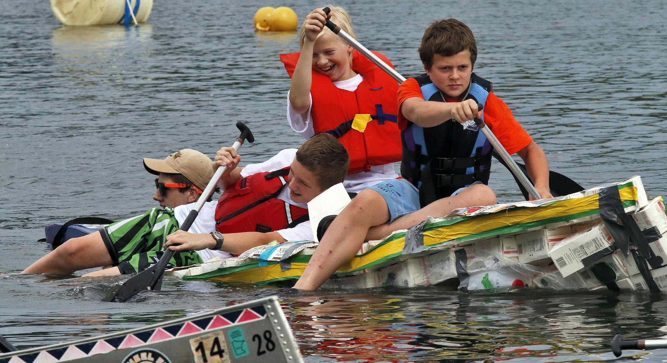 The Aquatennial's Milk Carton Boat Race at Lake Calhoun in Minneapolis. Not all entries stayed afloat long enough to cross the finish line. This entry sponsored by the Science Museum of St. Paul called the Mega Ample Boating Knuckleheads listed badly as it slowly headed back to shore.