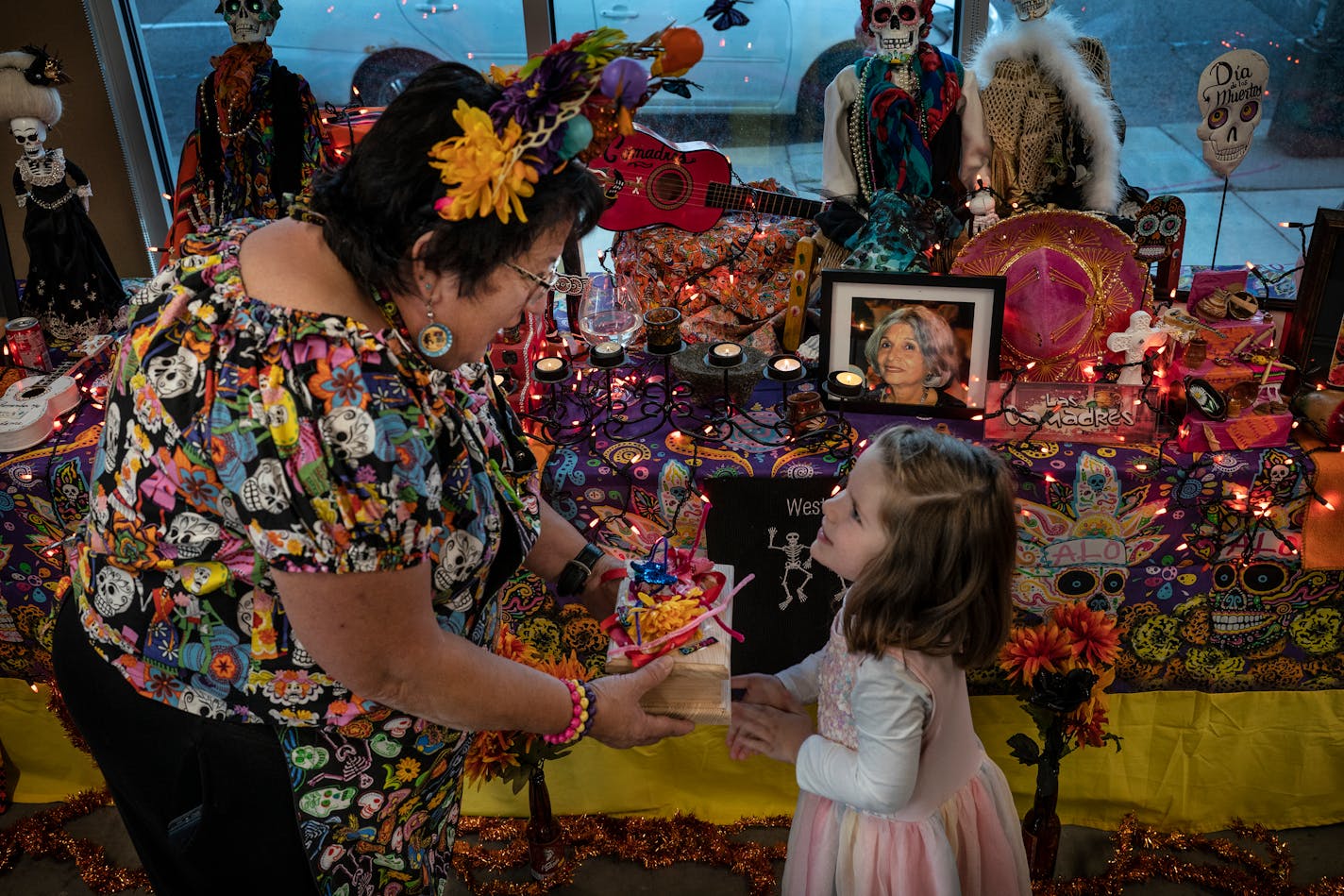 Lois Miller 4 right showed Debbie Luna an altar that she made with the help of her mom Bri Miller. Miller built this altar to remember her grandfather Papa Jim who died in 2013. Families gathered to build Day of the Dead altars during a workshop to remember their loves ones Tuesday night, Oct.26,2021 in St. Paul. The free workshop was taught by Debbie Luna and Estrada at through the West Side Community Organization. ] JERRY HOLT •Jerry.Holt@startribune.com