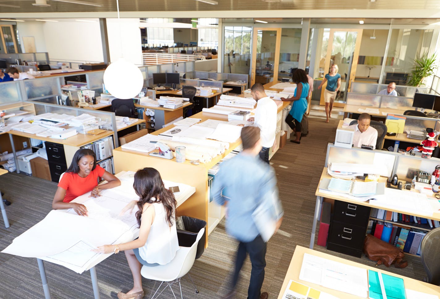 Interior Of Busy Modern Open Plan Office With Workers In