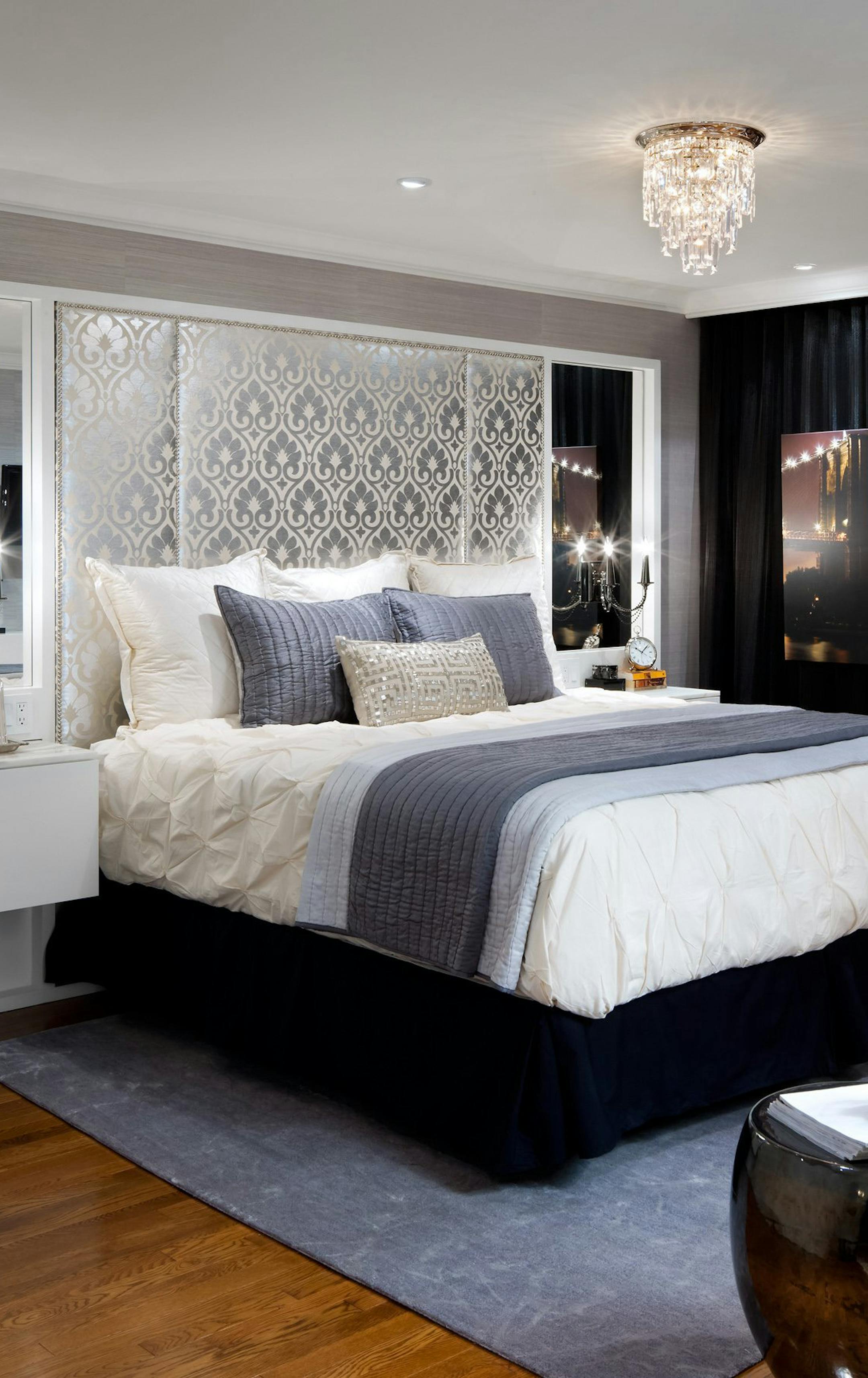 The new, larger bed was flanked with mirrored panels lit up by modern wall sconces. A custom-made headboard covered with a rich, silvery patterned fabric contrasts sharply with the far wall, which was painted black and draped in dark, wall-to-wall sheers. (Brandon Barre/MCT) ORG XMIT: 1148368