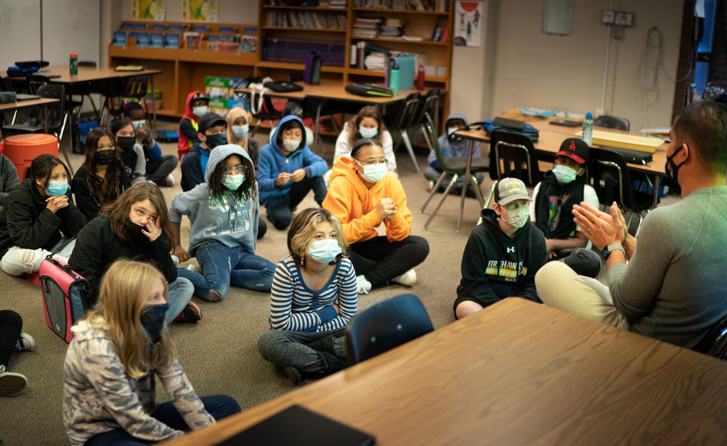 Masked 6th graders listen as Bounthavy Khamratthanome works on the class assignment to compare the biosystems of Earth and Mars to determine is life ever existed on the red planet. Thursday, Nov. 4, 2021, Nicollet Middle School, Burnsville, Minn. ] GLEN STUBBE • glen.stubbe@startribune.com