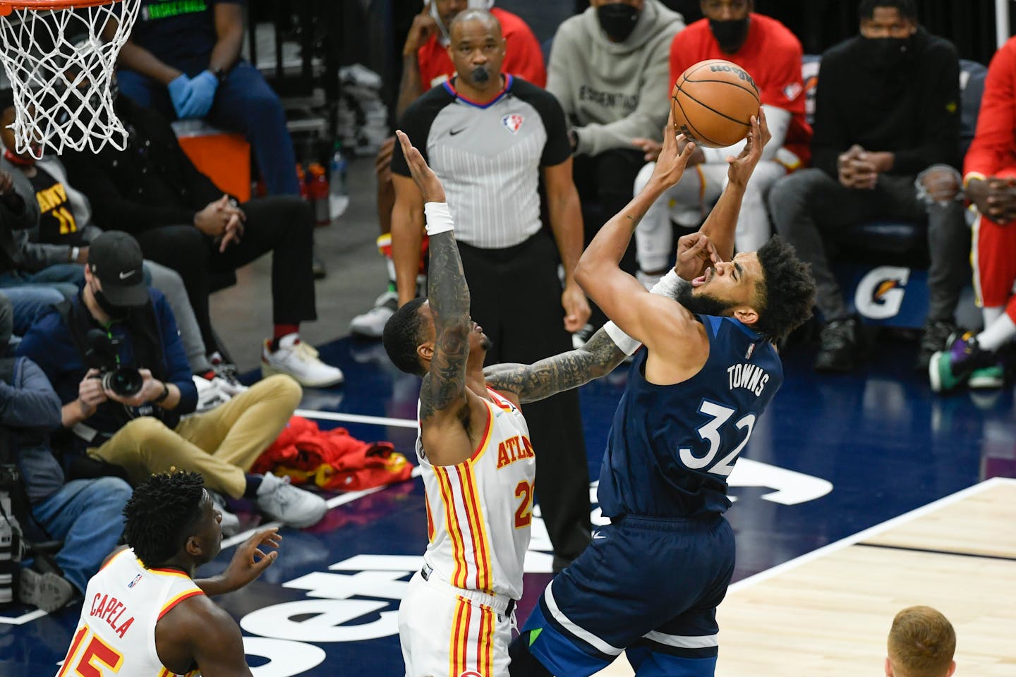 Minnesota Timberwolves center Karl-Anthony Towns, right, is fouled by Atlanta Hawks forward John Collins during the second half of an NBA basketball game Monday, Dec. 6, 2021, in Minneapolis. (AP Photo/Craig Lassig)