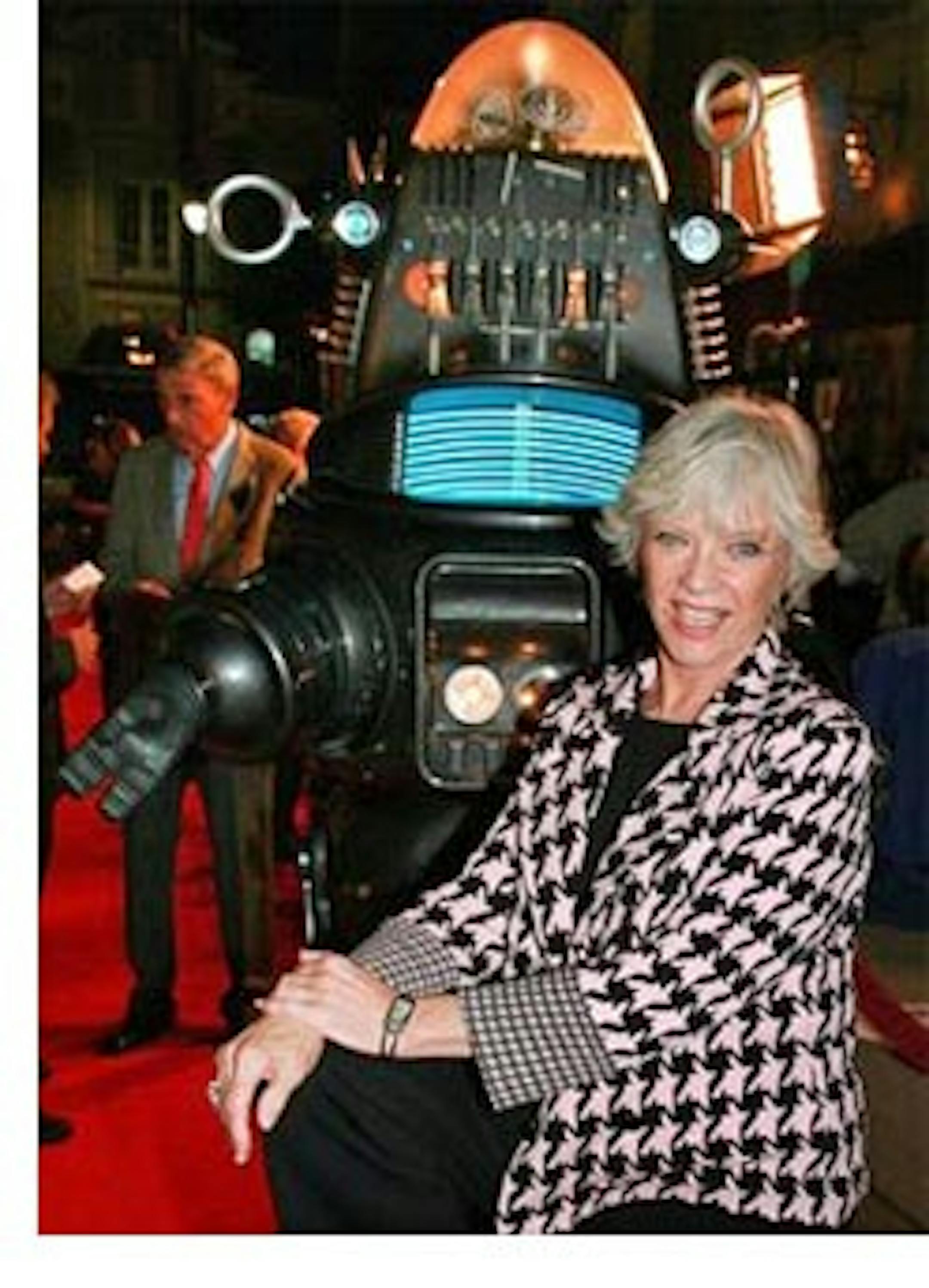 FILE-This Nov.8,2006, file photo supplied by Warner Home Video shows actress Anne Francis posing with Robby the Robot at a  screening to commemorate the 50th anniversary  of the film, "Forbidden Planet," in Los Angeles. Francis, who was the love interest in the 1950s science-fiction classic "Forbidden Planet" and later was sexy private eye Honey West" on TV, has died. She was 80. (AP Photo/Warner Home Video,Alan Berliner,File )