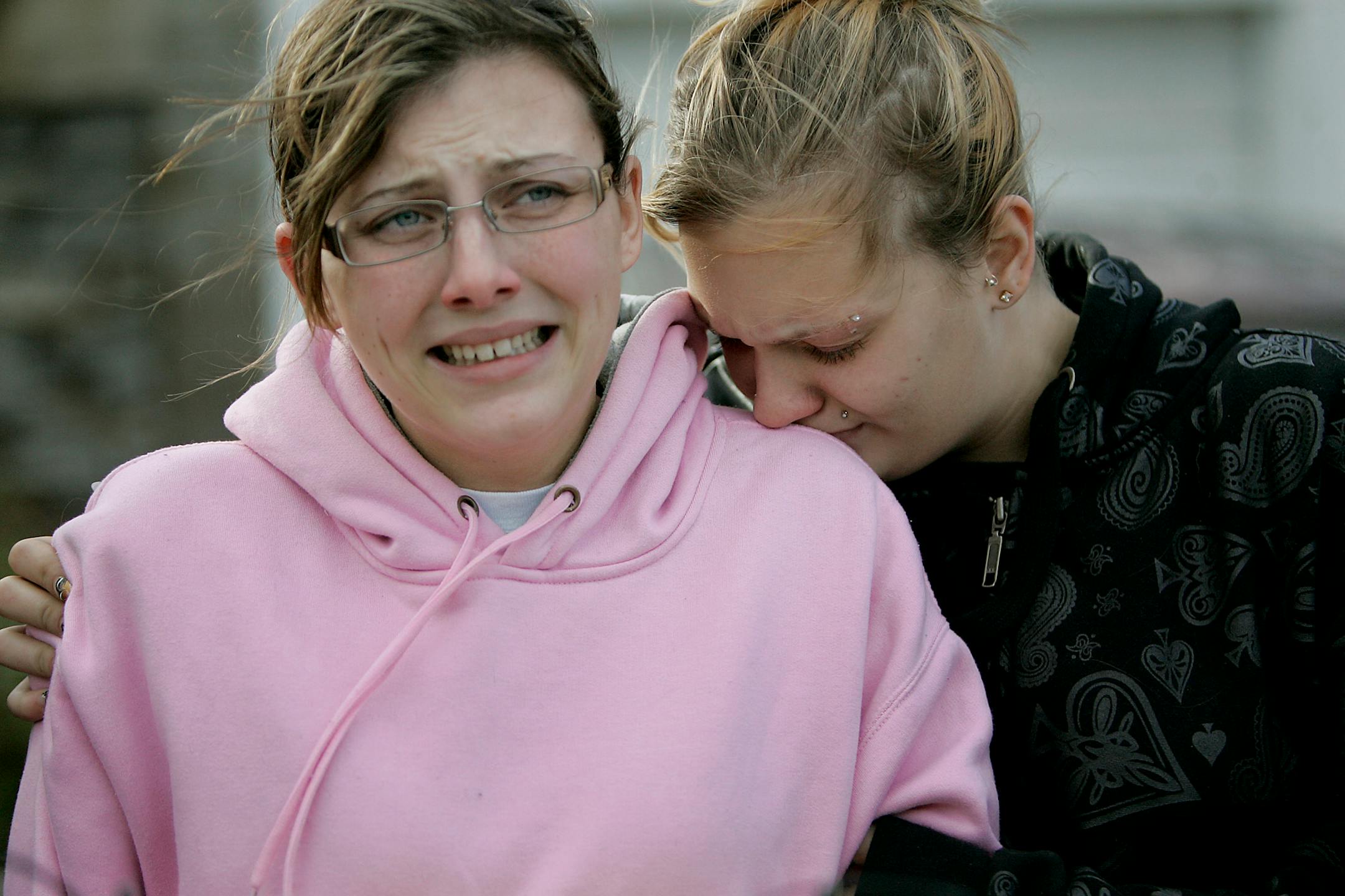 Embraced by Jacob MacKenzie's sister, Ashley MacKenzie, right, Jayna Emerson wept as she pleaded for the return of her boyfriend, Alfredo Gutierrez-Gonzales, to turn himself in. Gutierrez-Gonzales fled after being accused of killing Jacob MacKenzie early Sunday.