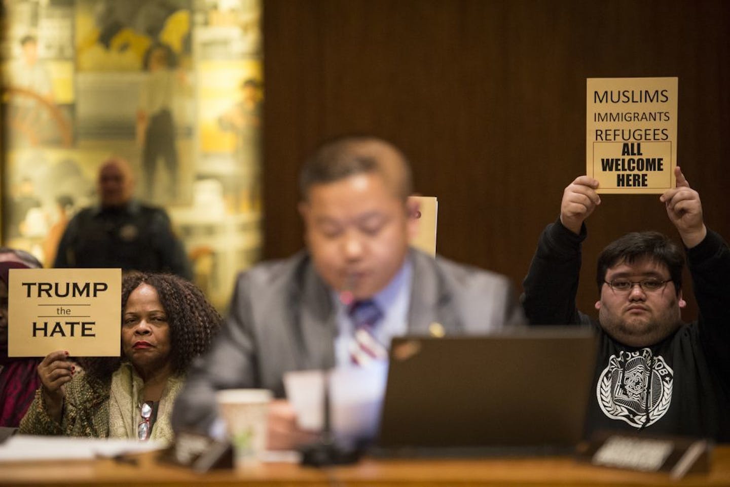 Demonstrators held anti-Trump signs at Wednesday's St. Paul City Council meeting.