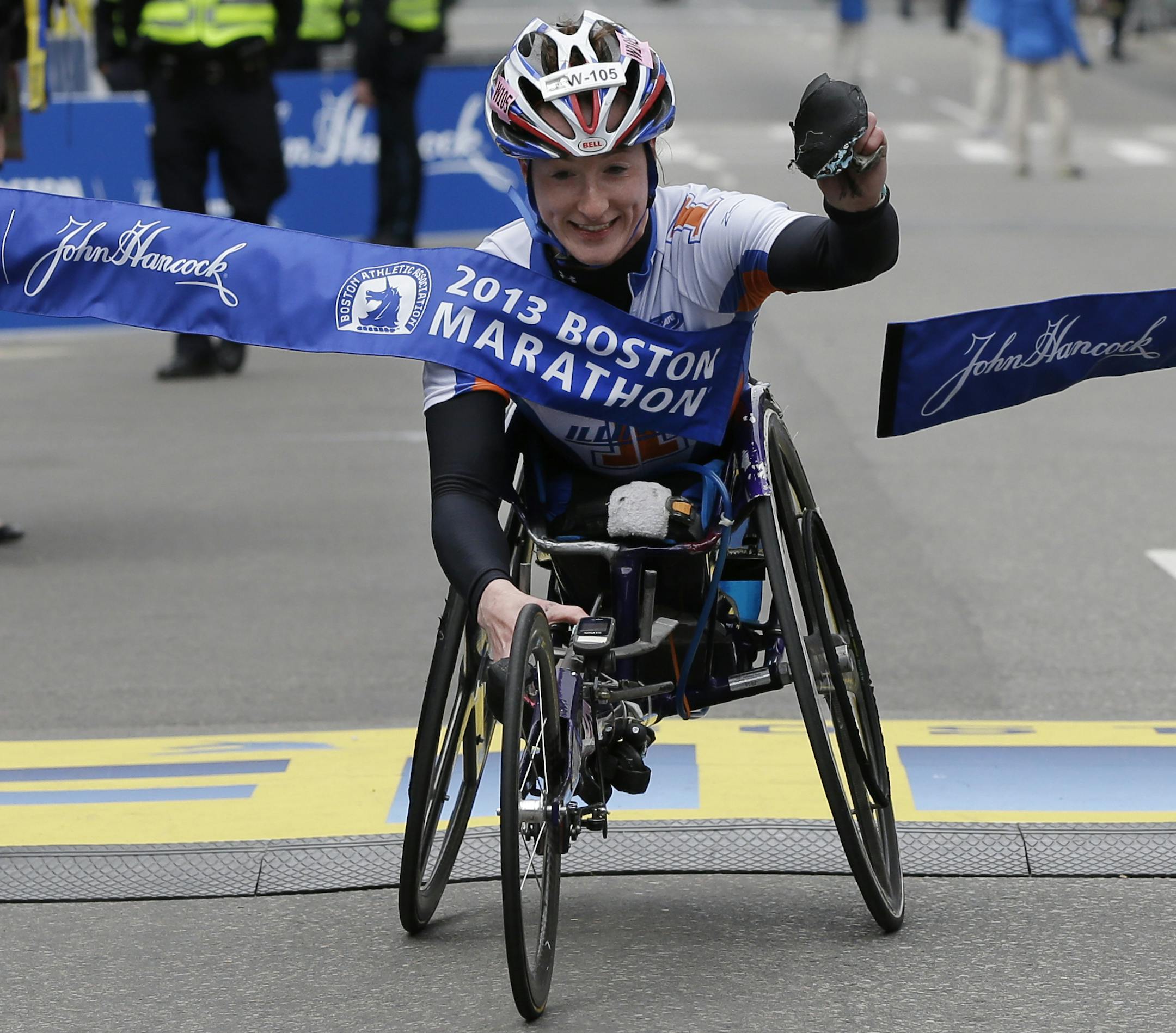 Tatyana McFadden of the United States breaks the tape as she wins the women's wheelchair division of the 2013 Boston Marathon in Boston Monday, April 15, 2013. (AP Photo/Elise Amendola) ORG XMIT: MIN2013041919145326