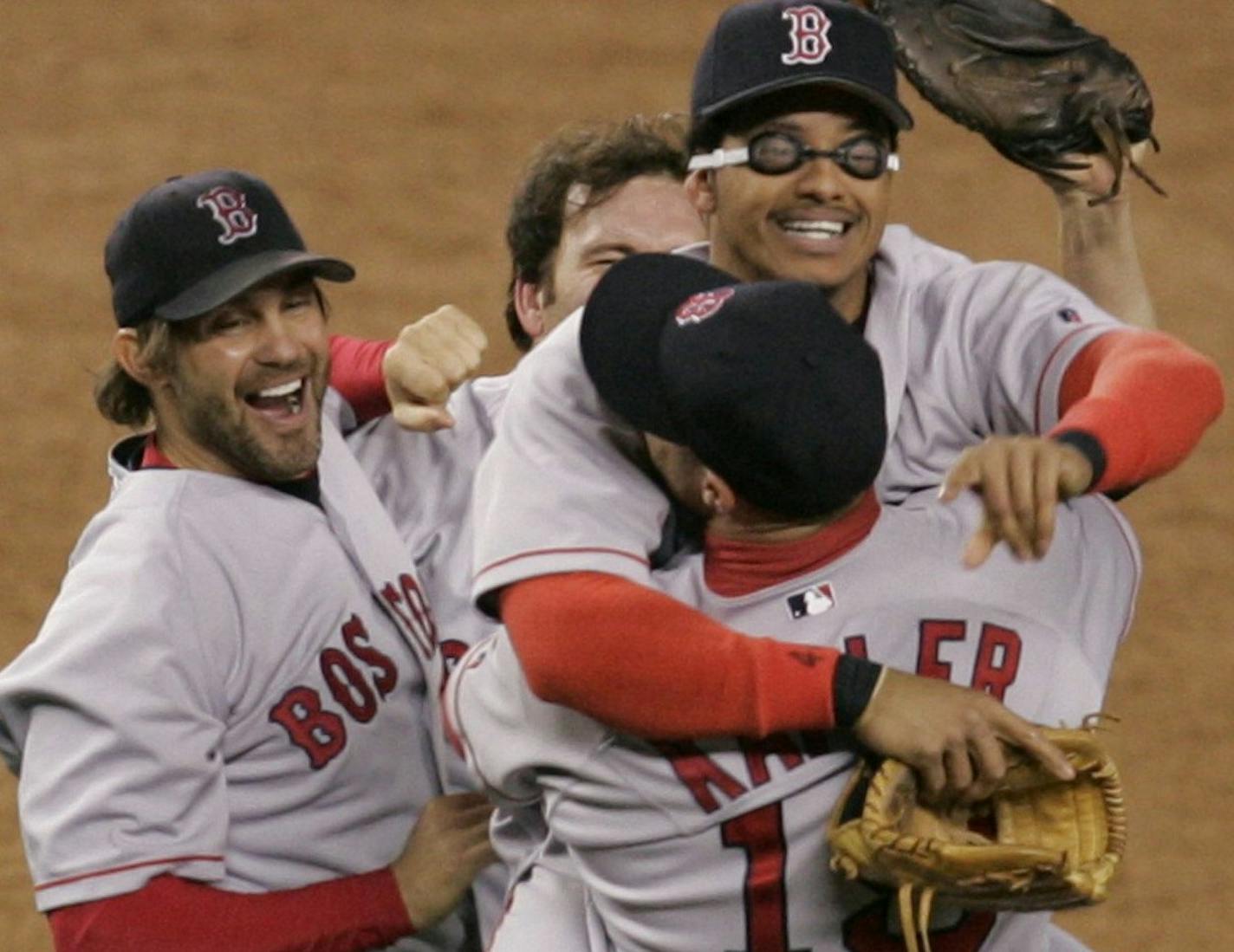 Boston Red Sox's Gabe Kapler, foreground, hugs Orlando Cabrera as Curt Leskanic, left, joins in after Boston defeated the New York Yankees 10-3 in the deciding game of the AL championship series Wednesday, Oct. 20, 2004, in New York. (AP Photo/Amy Sancetta) ORG XMIT: NYY164