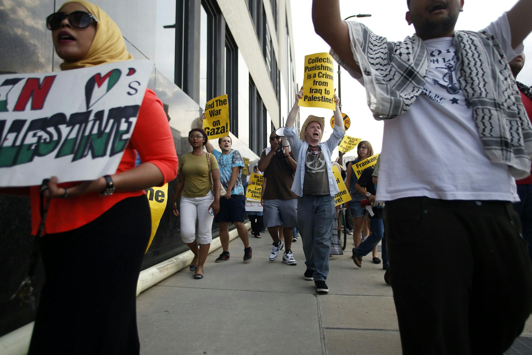 Pro Palestine Protesters march away from the Star Tribune building after their "theatrical die in" on Wednesday evening. ] Pro palestine protesters demonstrated in front of the Star Tribune building with a "theatrical die in," where people laid on the sidewalk as the names and stories of people killed in the conflict were read aloud. The protest ended with chants of "Gaza, Gaza, don't you cry. Our hearts for you shall never die." MONICA HERNDON monica.herndon@startribune.com Minneapolis, MN 08/0