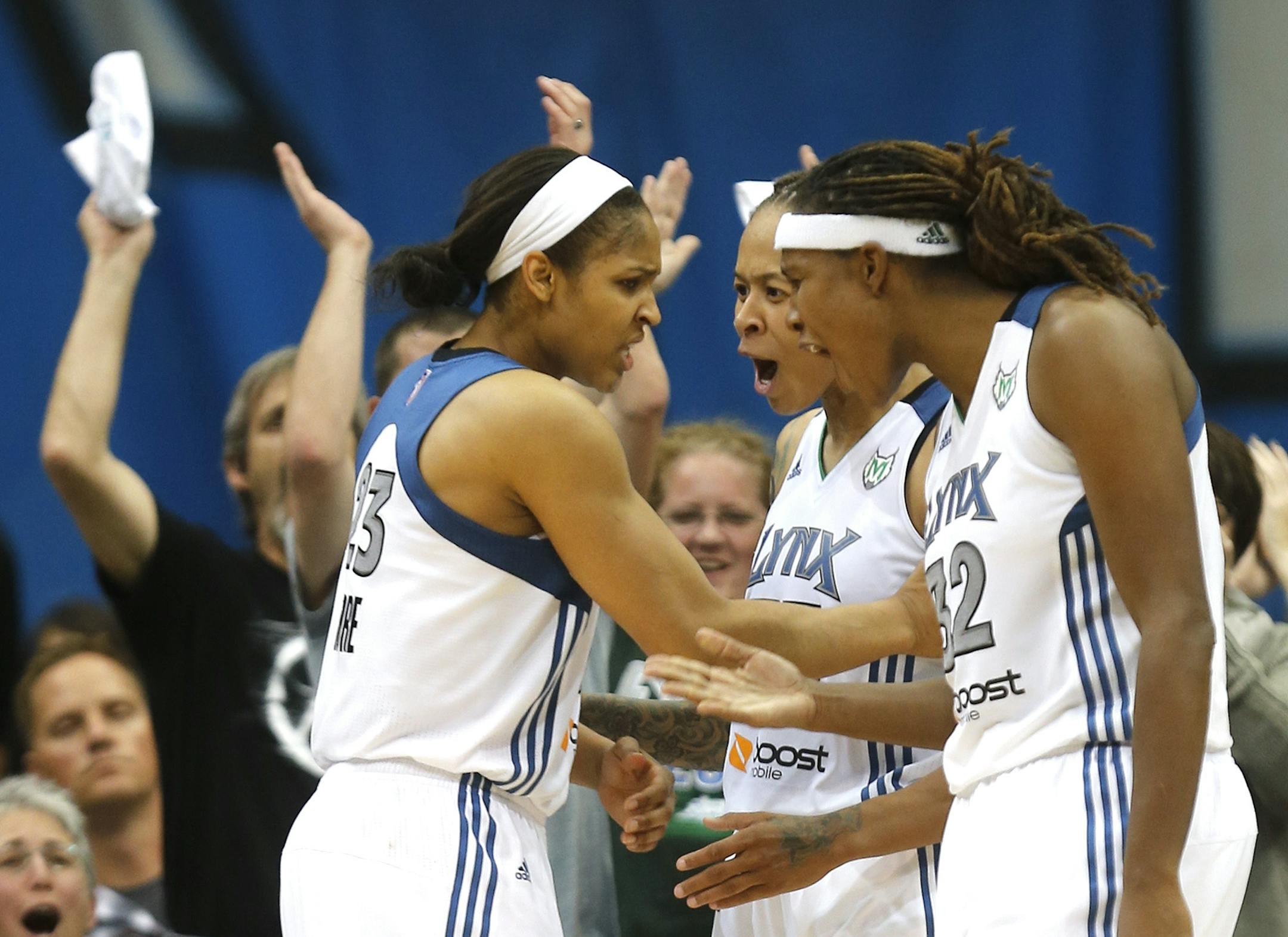 Lynx Seimone Augustus and Rebekkah Brunson celebrated with teammate Maya Moore after she blocked the shot of the Storm's Katie Smith during the second half of the first game of the WNBA playoffs at Target Center in Minneapolis Min., Friday September 28, 2012. Lynx won 78-10