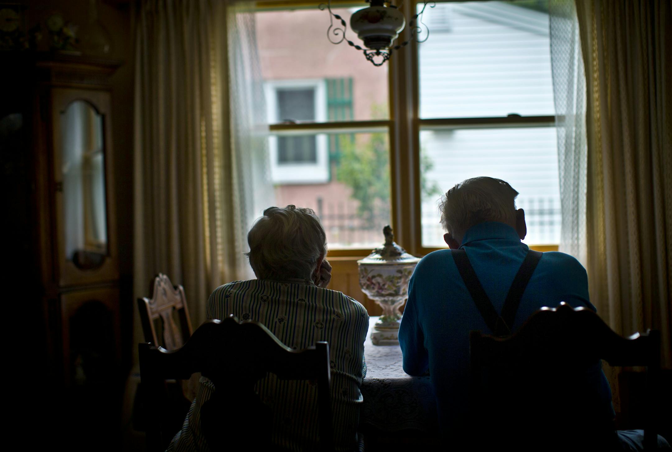 A Rochester woman has admitted that she bilked her elderly neighbors out of more than $800,000 with a sob story about having to go to Washington, D.C., to tend to her dead daughter's affairs and also to go to Italy for business purposes. The couple, who didn't want to be identified, looked out the picture window that faces that neighbor's house on Friday July 26, 2013 in Rochester, Minn. ] (RENEE JONES SCHNEIDER * reneejones@startribune.com)