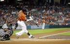Houston Astros' Carlos Gomez (30) swings at a pitch during the first inning of a baseball game against the Arizona Diamondbacks Friday, July 31, 2015,