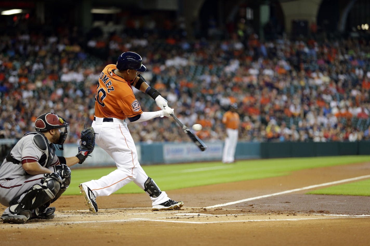 Houston Astros' Carlos Gomez (30) swings at a pitch during the first inning of a baseball game against the Arizona Diamondbacks Friday, July 31, 2015, in Houston. (AP Photo/David J. Phillip)