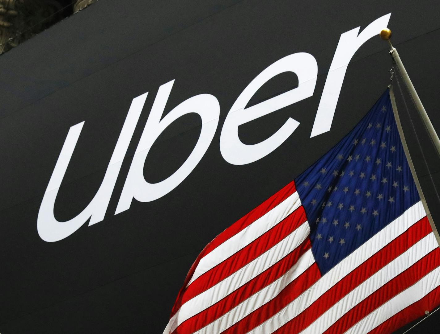 FILE - In this May 10, 2019, file photo a banner for Uber is draped on the front of the New York Stock Exchange before the world's largest ride-hailing service holds its initial public offering. Uber is letting passengers request a more comfortable ride if they&#x2019;re willing to pay. The ride-hailing giant launched &#x201c;comfort&#x201d; rides Tuesday, July 9. (AP Photo/Mark Lennihan, File)