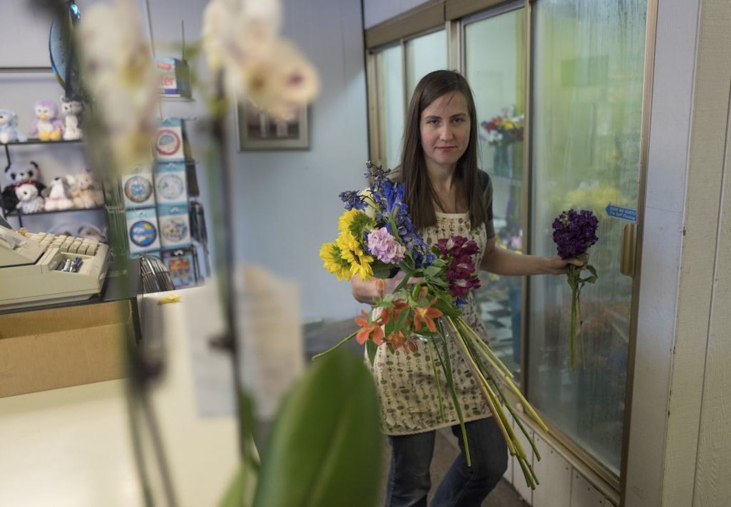 Ashley Weed owner of Jandrich Floral Shop worked on a flower arrangement Thursday July 5, 2018 in St. Paul, MN.