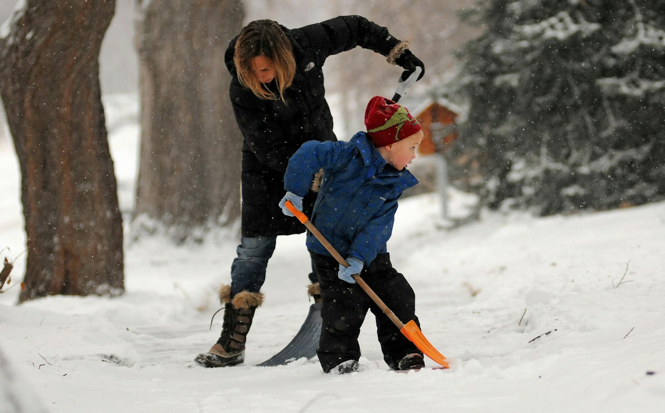 Lissa Pawlisch shoveled the sidewalk with her 4-year-old son Graham Bailey in front of their home on Emerson Ave South in Minneapolis on Monday morning January 23,2012.